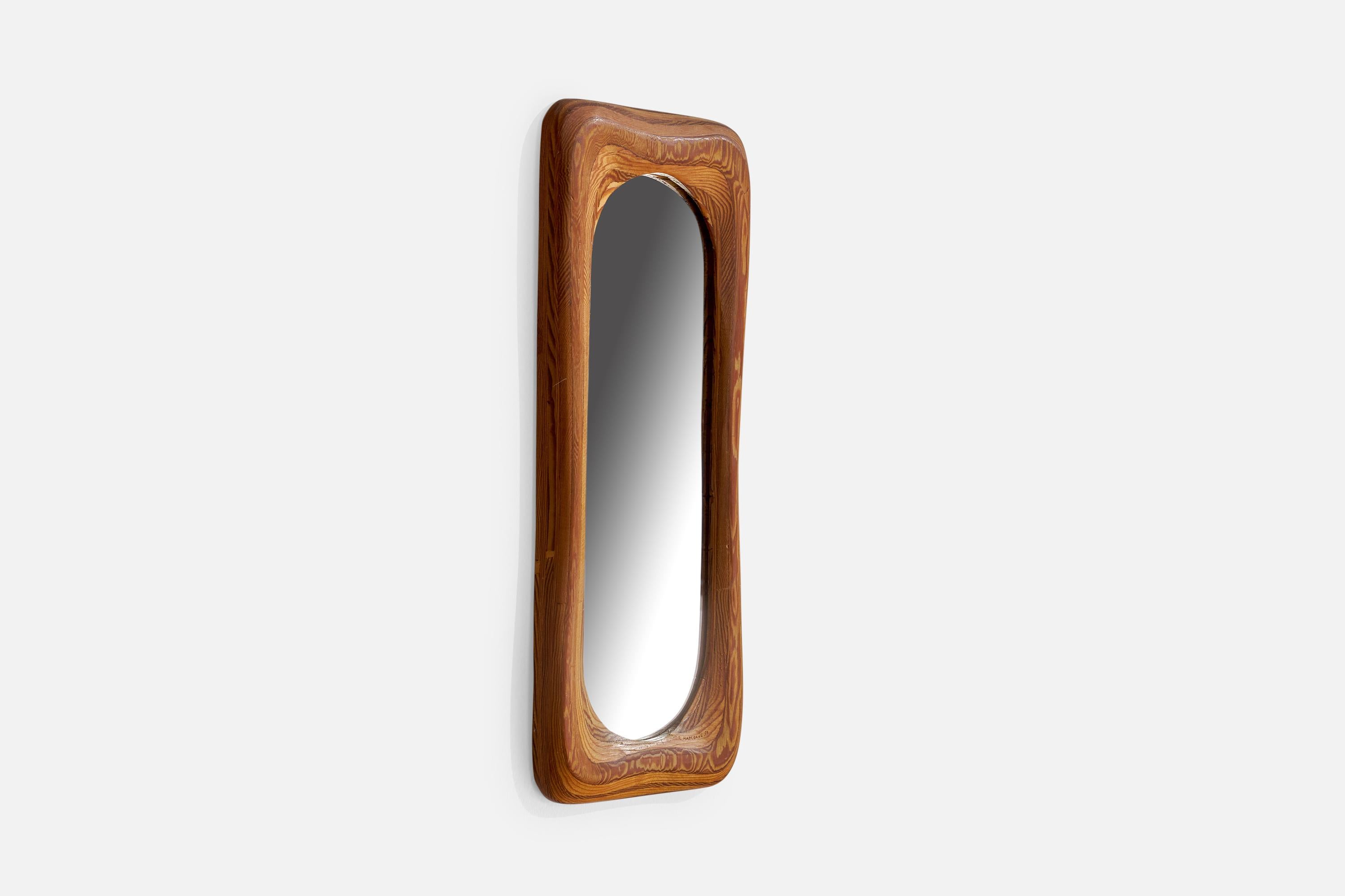 A stack-laminated pine wall mirror designed and produced by Robert Hargrave, USA, 1980.