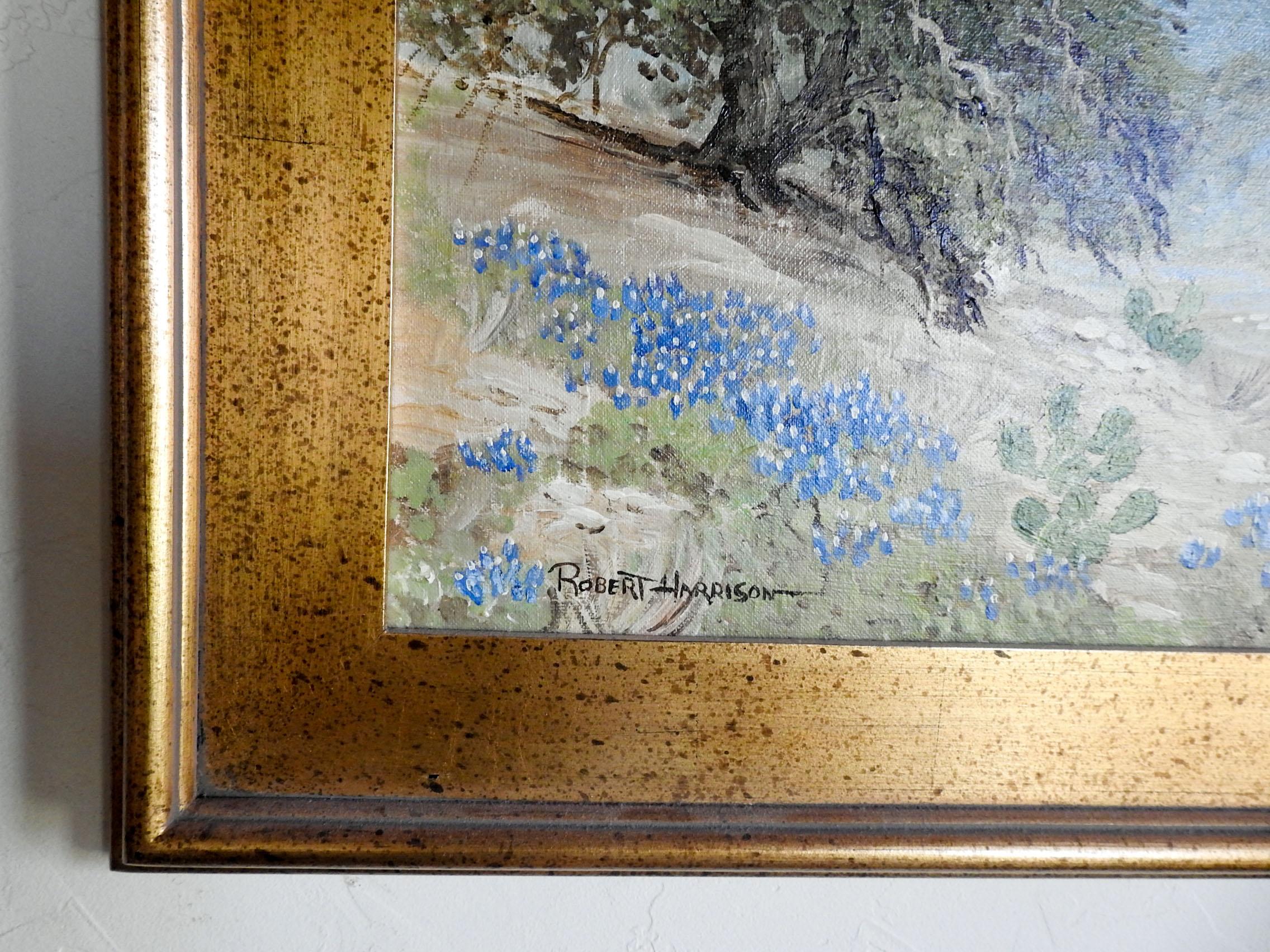 Oil on canvas board by Robert Harrison of Texas hill country bluebonnet landscape. Signed lower left corner. Displayed in giltwood frame, opening size 24
