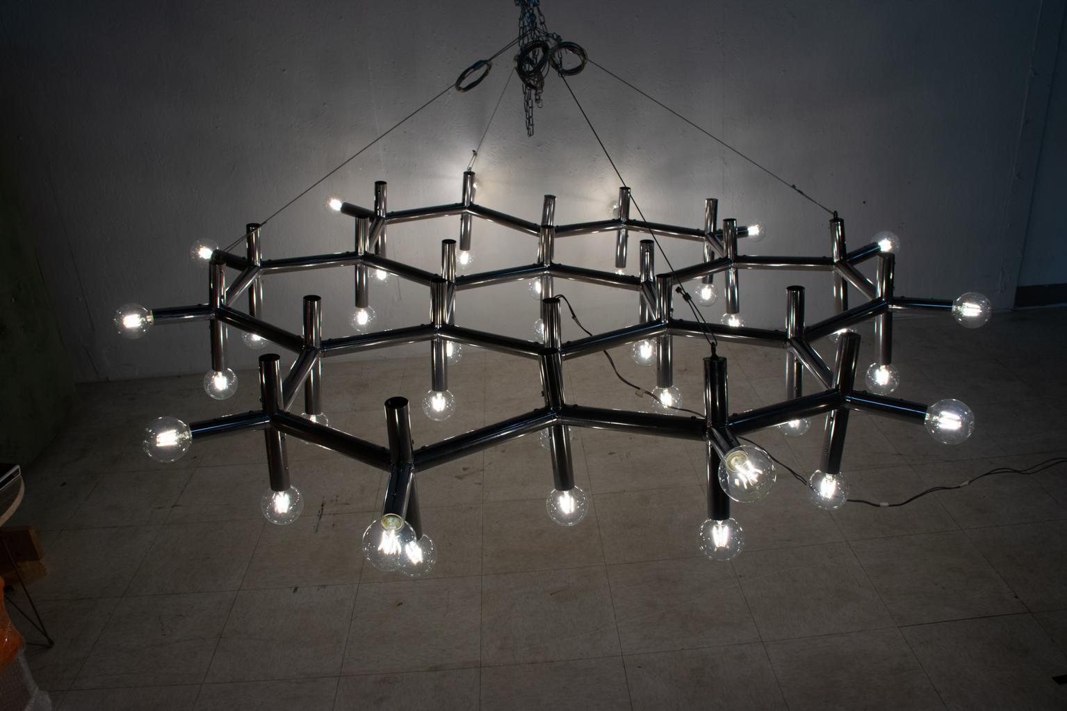 For your consideration, an incredible hanging chandelier by Robert Haussmann. 36 bulbs (included). Beautiful atomic composition in the shape of a hexagon. Switzerland 1960s. No marking present. New sockets. Dimensions: 79