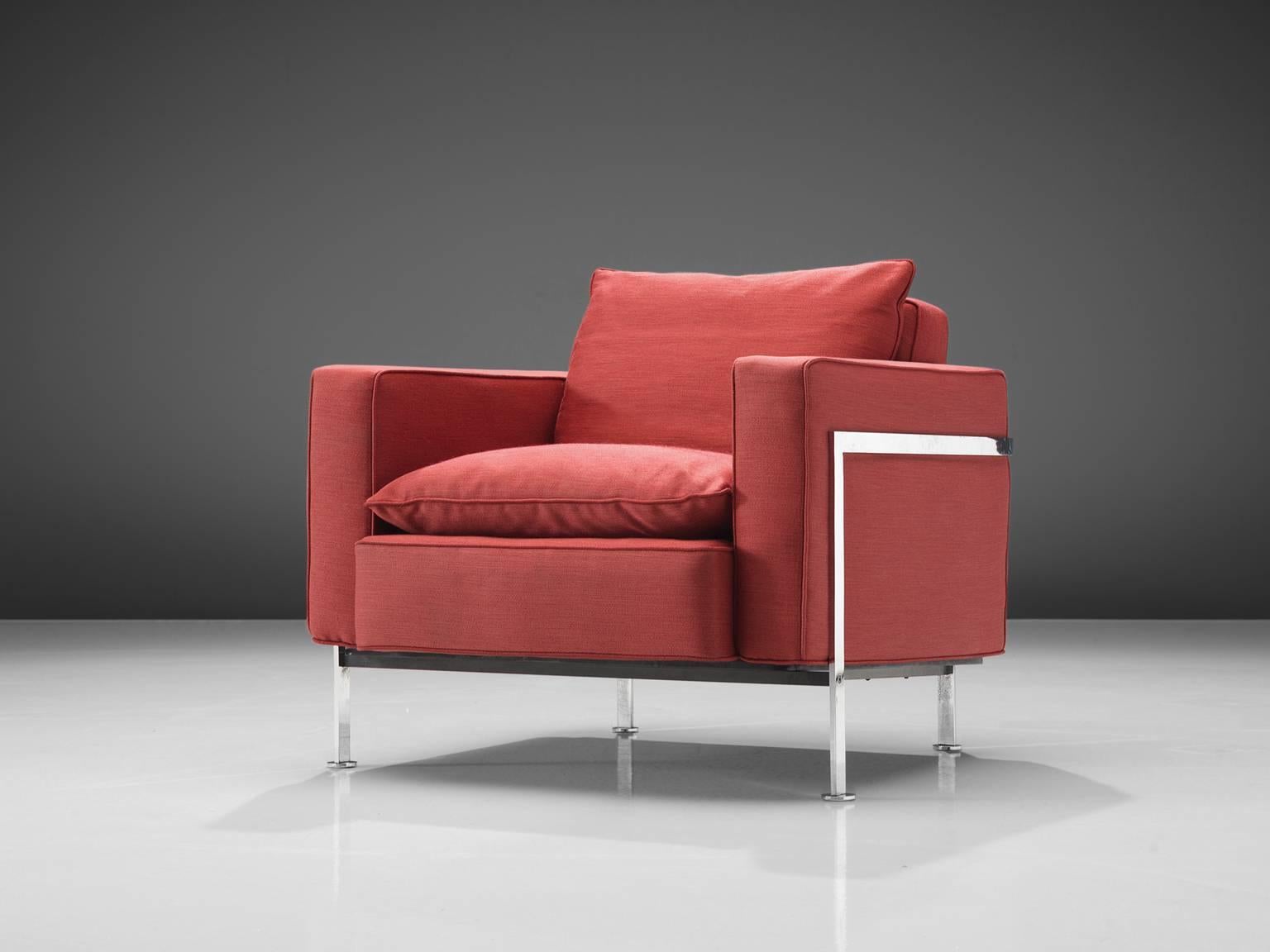Robert Hausmann for Stendig, armchair in red fabric, steel, Switzerland, 1954.

This comfortable armchair is designed with a chromed iron frame that functions as a basket for the cushions on the inside. The thick back and seat cushion provide an