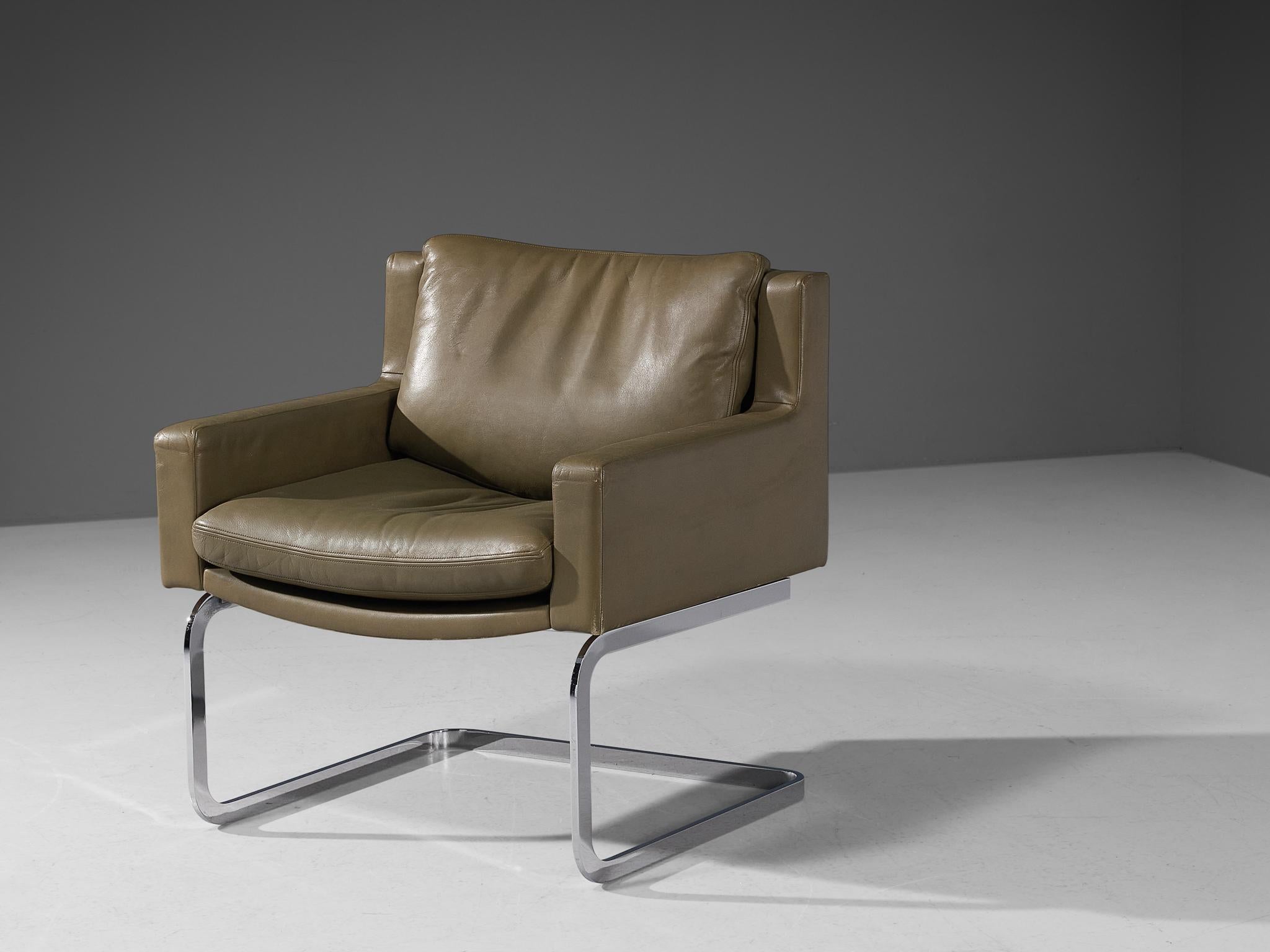 Robert Haussmann for De Sede, armchair model 'DS-201', chrome-plated metal, leather, Switzerland, designed in 1957 

A design by Robert Haussmann that features a cubic shaped structure. The backrest runs into the armrests by means of a