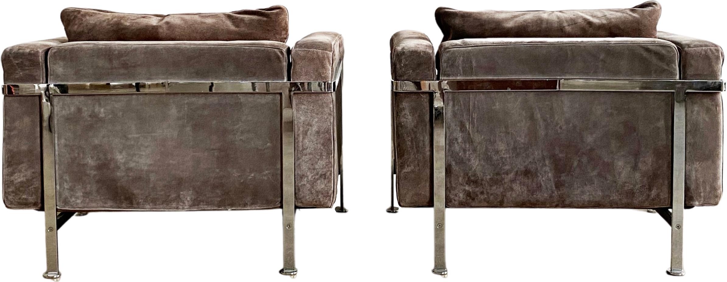 Highly coveted Robert Haussmann De Sede RH 302 lounge armchairs. These suede armchairs are designed with a chromed iron frame that functions as a basket for the cushions. They are heaven to sit in. The thick back and seat cushion provide an