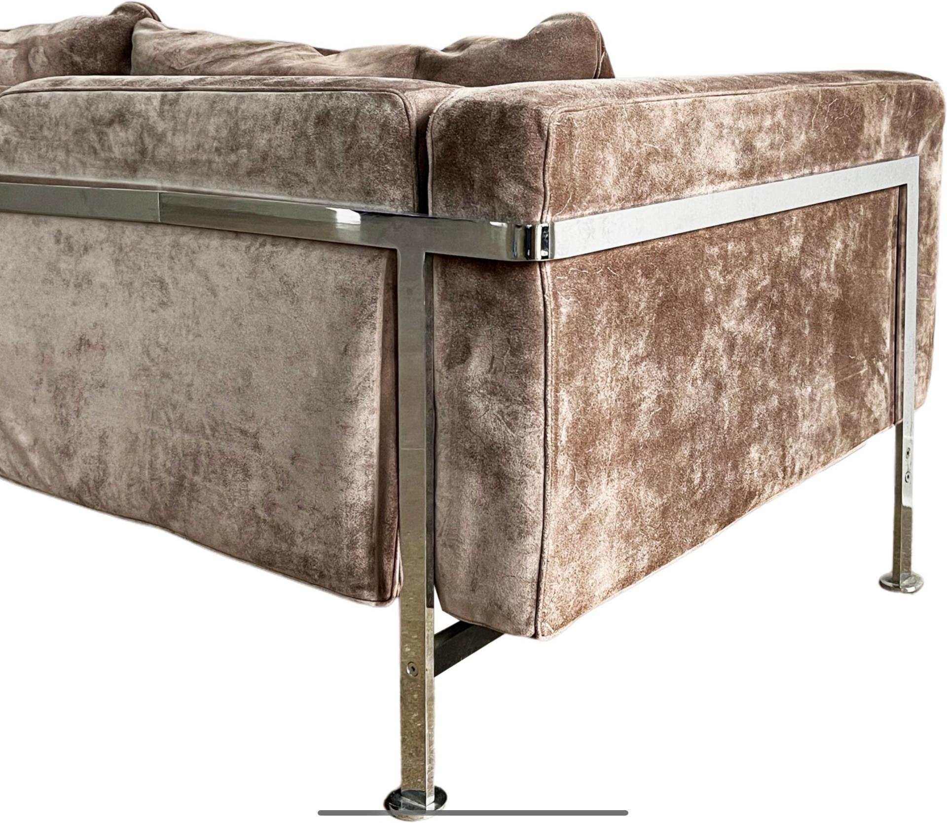 Comfort meets luxury with this gorgeous piece that you can melt into. Highly coveted Robert Haussmann for De Sede RH 302 Sofa. This suede sofa is designed with a chromed iron frame that functions as a basket for the cushions. It is heaven to sit in.