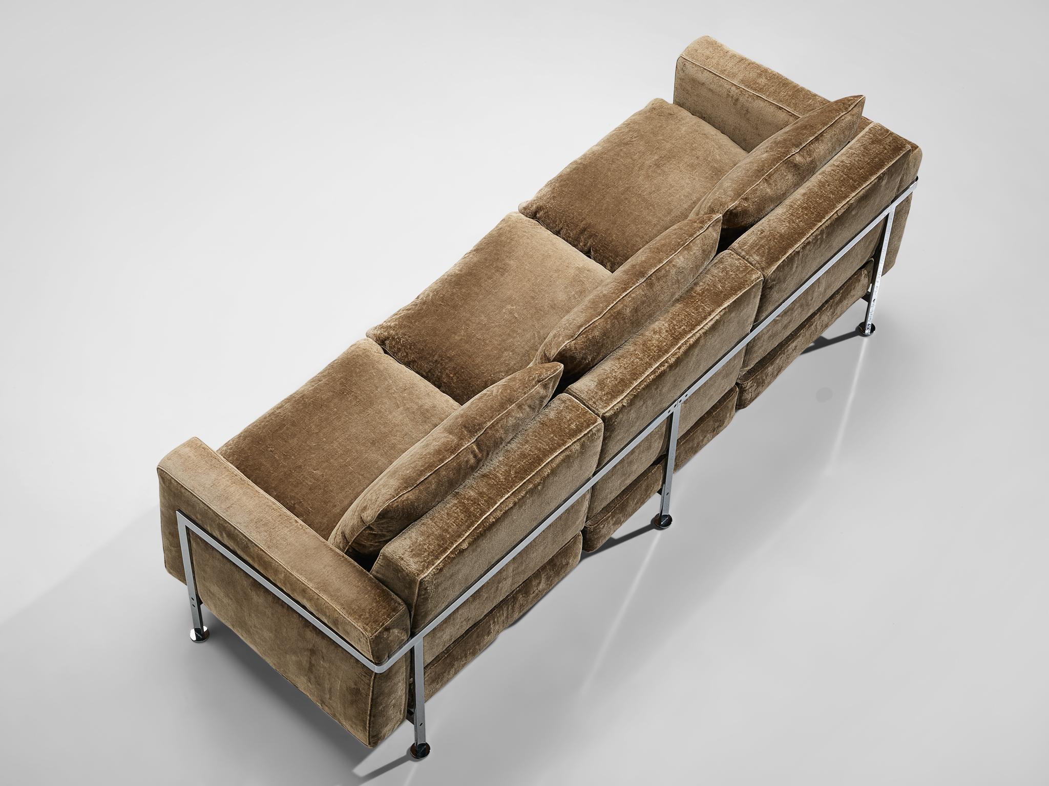 Robert Hausmann for De Sede, sofa in light brown velvet, Switzerland, 1954.

This comfortable velvet sofa is designed with a chromed iron frame that functions as a basket for the cushions on the inside. The thick back and seat cushion provide an