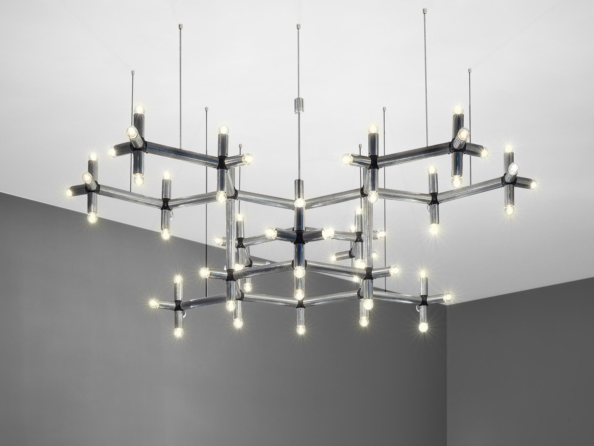 Robert Haussmann, chandelier, polished steel with 70 bulbs, Europe, 1970s.

This beautiful chandelier is executed in chromed steel and features a frame that spreads out as if it were a natural entity. The frame consists of multiple branches that are