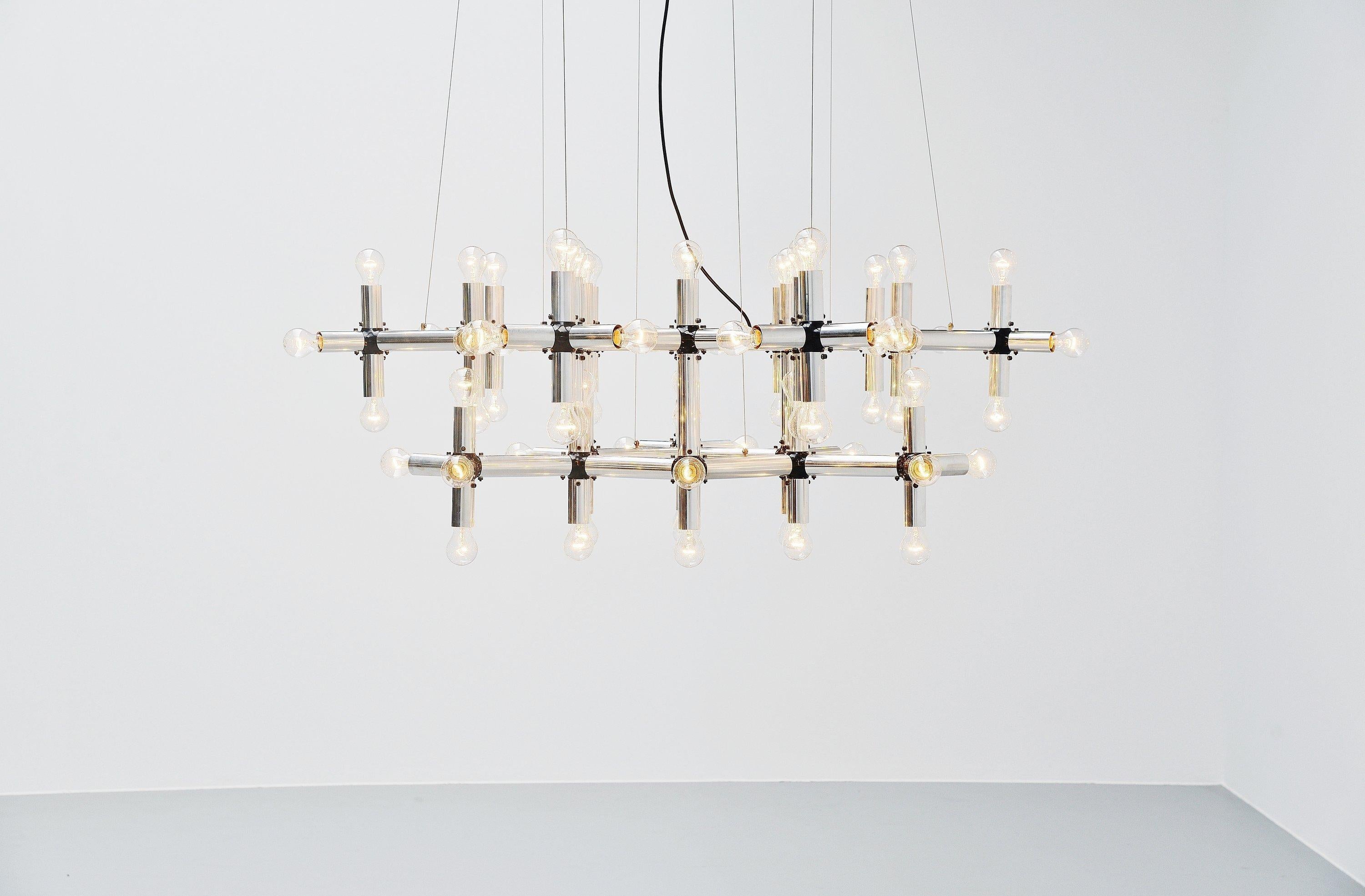 Monumental 'lichtstruktur' chandelier designed by Robert Haussmann and manufactured by Swiss lamp, Switzerland, 1969. The lamp was designed by the architect Robert Hausmann and it was a modular system, could be built however wanted. Was often used