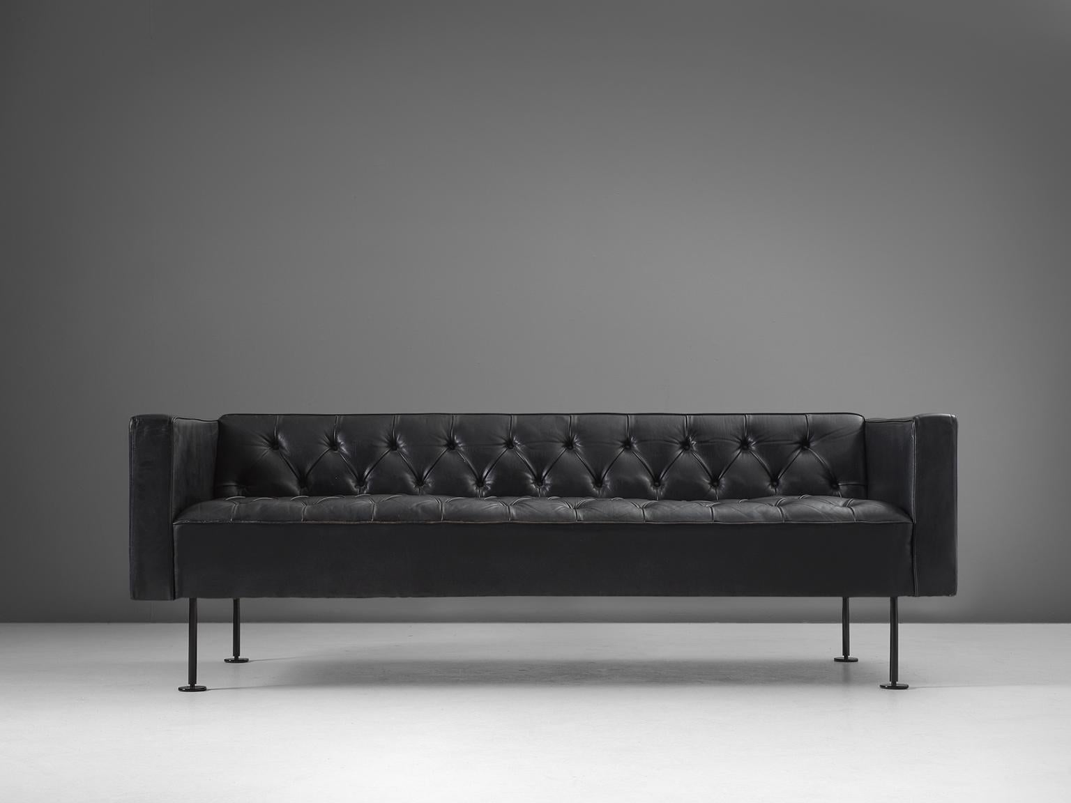 Robert Haussmann, sofa in leather and metal, 1970s, Switzerland. 

This extremely comfortable padded three-seat settee is designed by Robert Haussmann (1931-). The design has a classic appearance due to the tufted seat, while the combination with