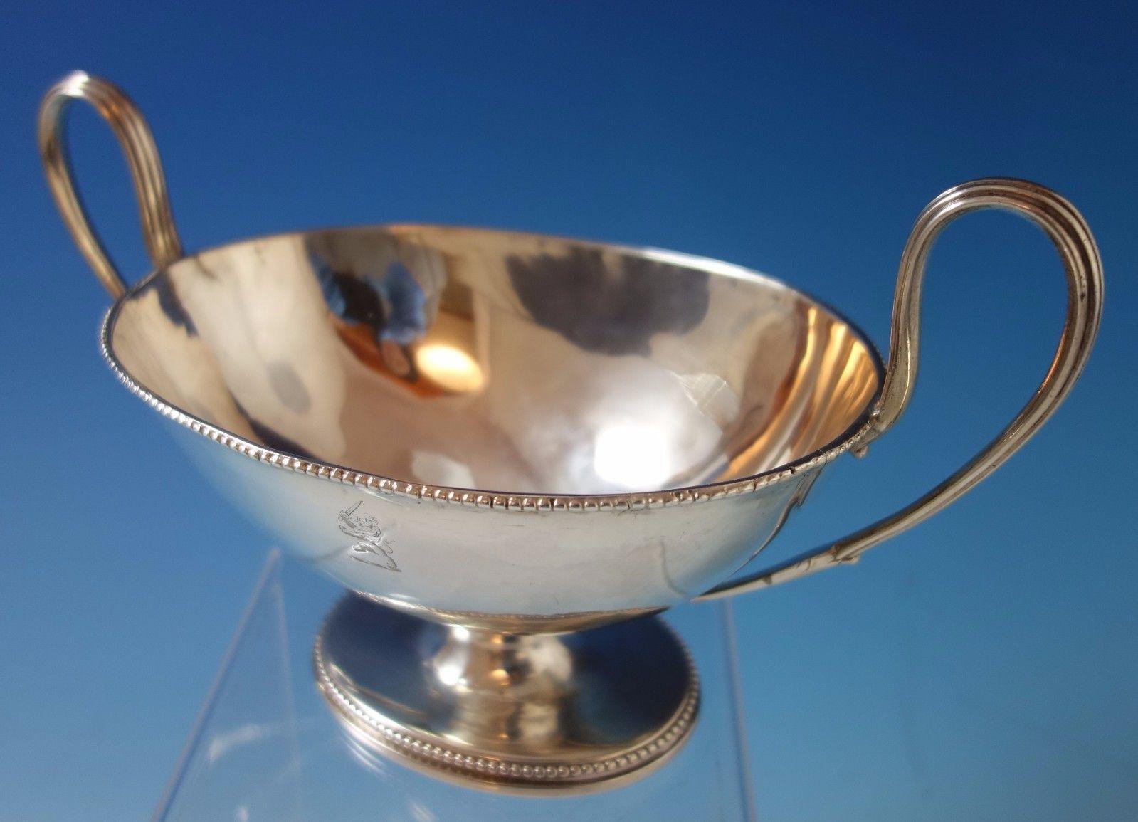 English sterling silver gravy boat. It was made in London by Robert Hennell I in 1780. This piece weighs 11.3 troy ounces and measures 5 1/2 x 9. It features a crest on one side (see photos), and is in good vintage condition. (No cover).