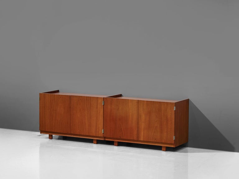 Robert heritage, two cabinets, teak, United Kingdom, 1960s

Midcentury small sideboards in teak. The small cabinets are equipped with doors and offer plenty of storage space. They rest on short rectangular shaped legs. The design of this set of