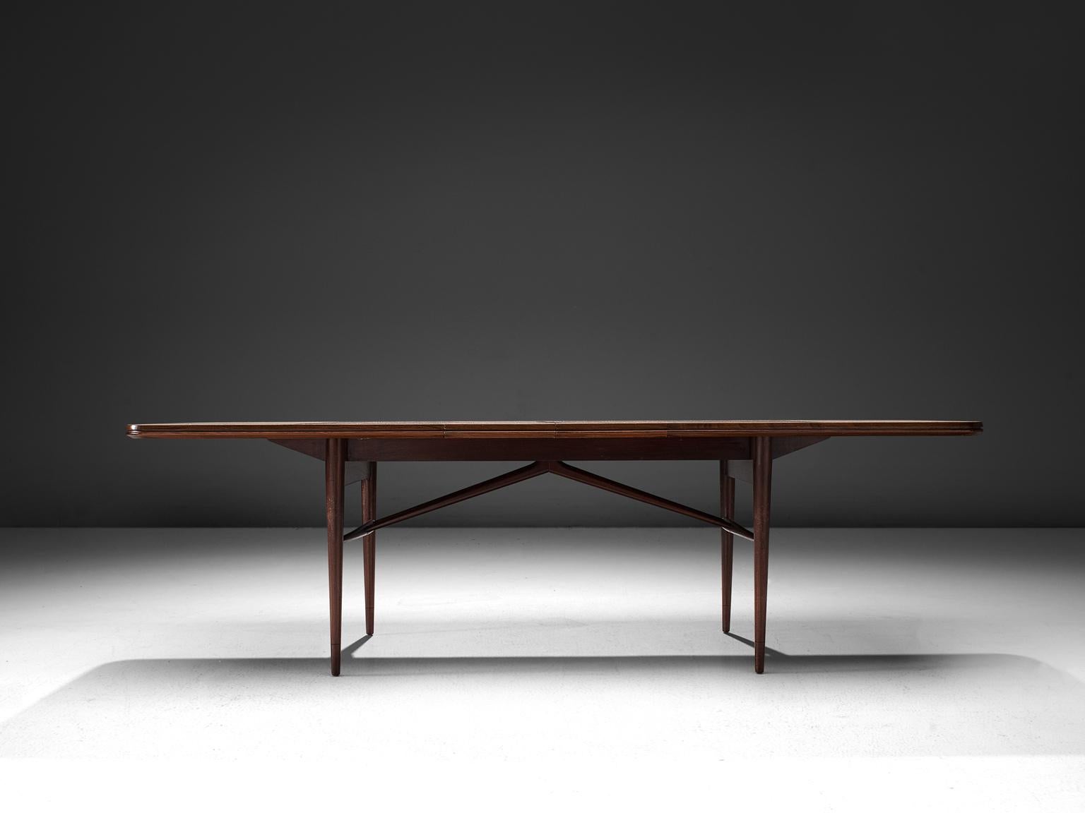 Robert Heritage for Archie Shine, dining table, teak, mahogany, England, 1950s. 

This dining table is executed in teak and mahogany and features elegant details that turn this simplistic table in a wonderfully designed piece. The rods underneath