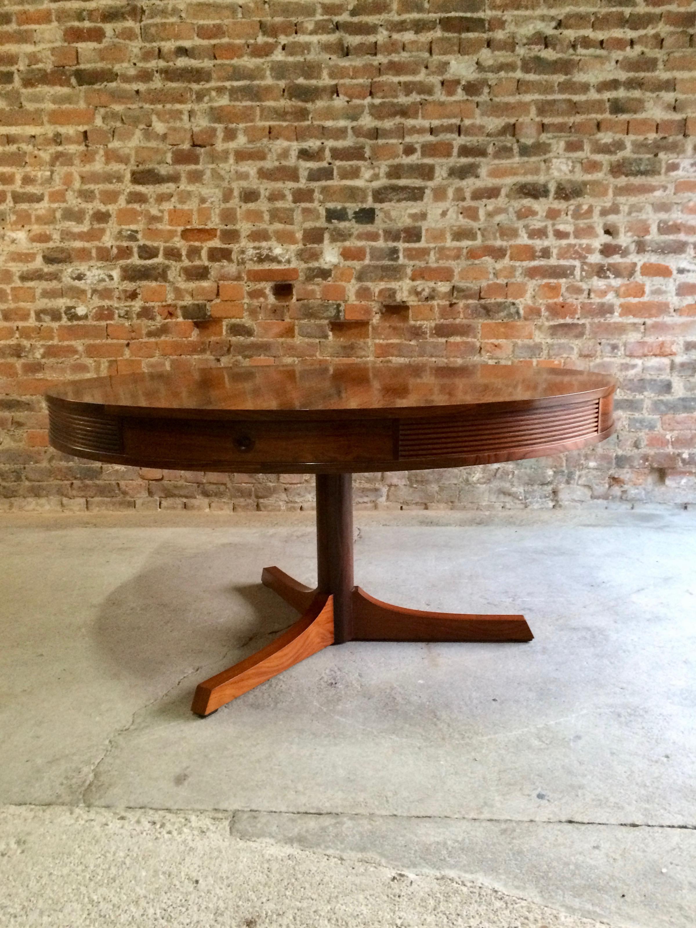 Robert Heritage for Archie Shine rosewood drum dining table designed in 1953, the circular rosewood top with four matching drawers over a tri pod mahogany pedestal base.

Condition report: Offered in very good condition with very little wear,