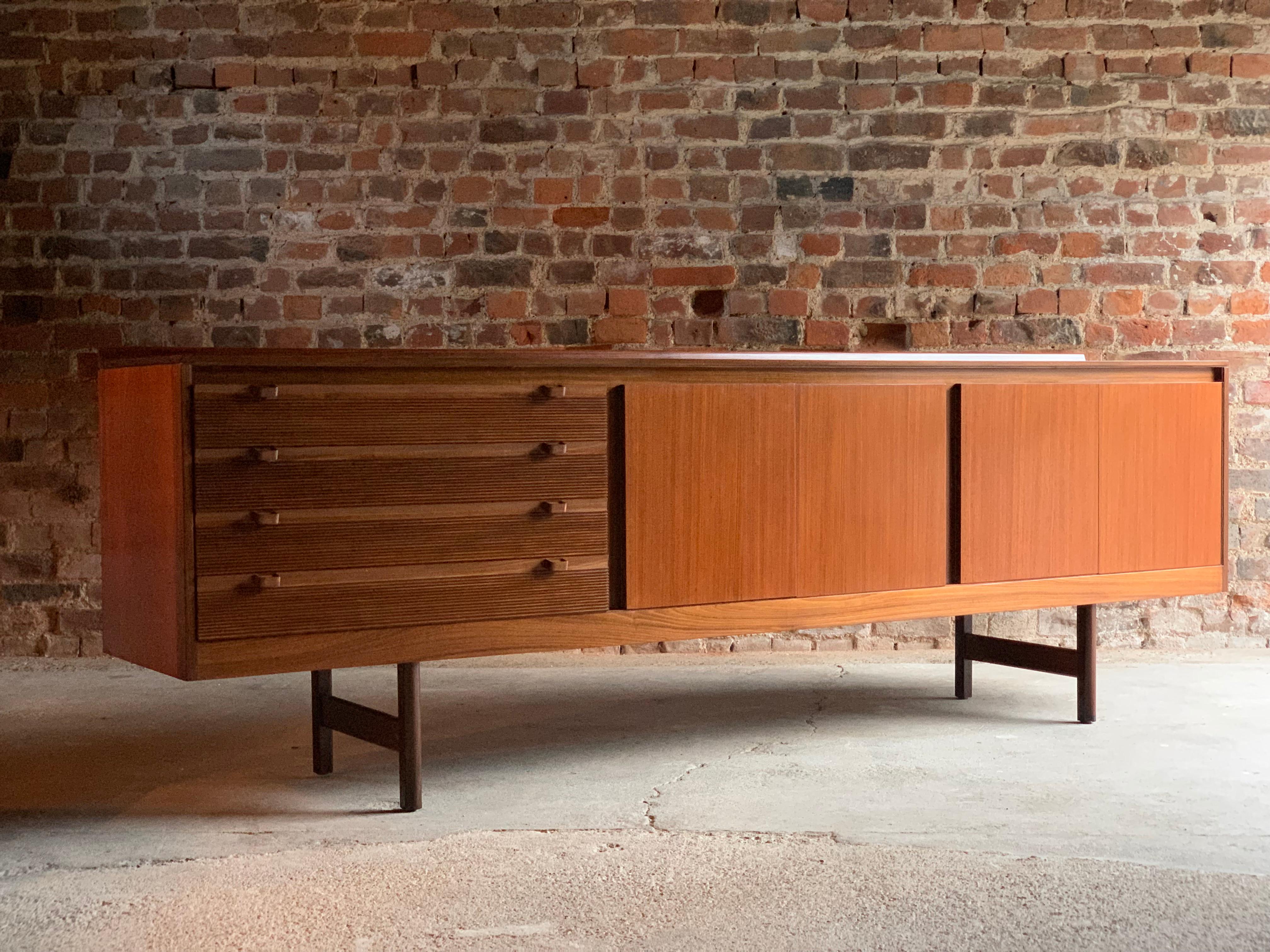 Robert Heritage Knightsbridge Model Teak sideboard credenza for Archie Shine circa 1960s, the rectangular top over four ridged drawers with angled drawer pulls, two double cupboards each with internal shelving raised on four straight