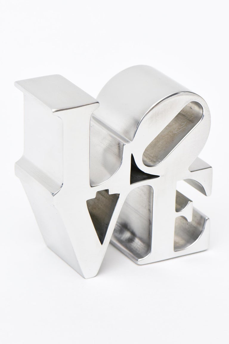 This iconic small Robert Indiana LOVE chrome paperweight sculpture originally designed by Robert Indiana from the 60's was put in small editions and sold at museum stores such as MOMA and others in the 70's. These are now hard to come by. It has