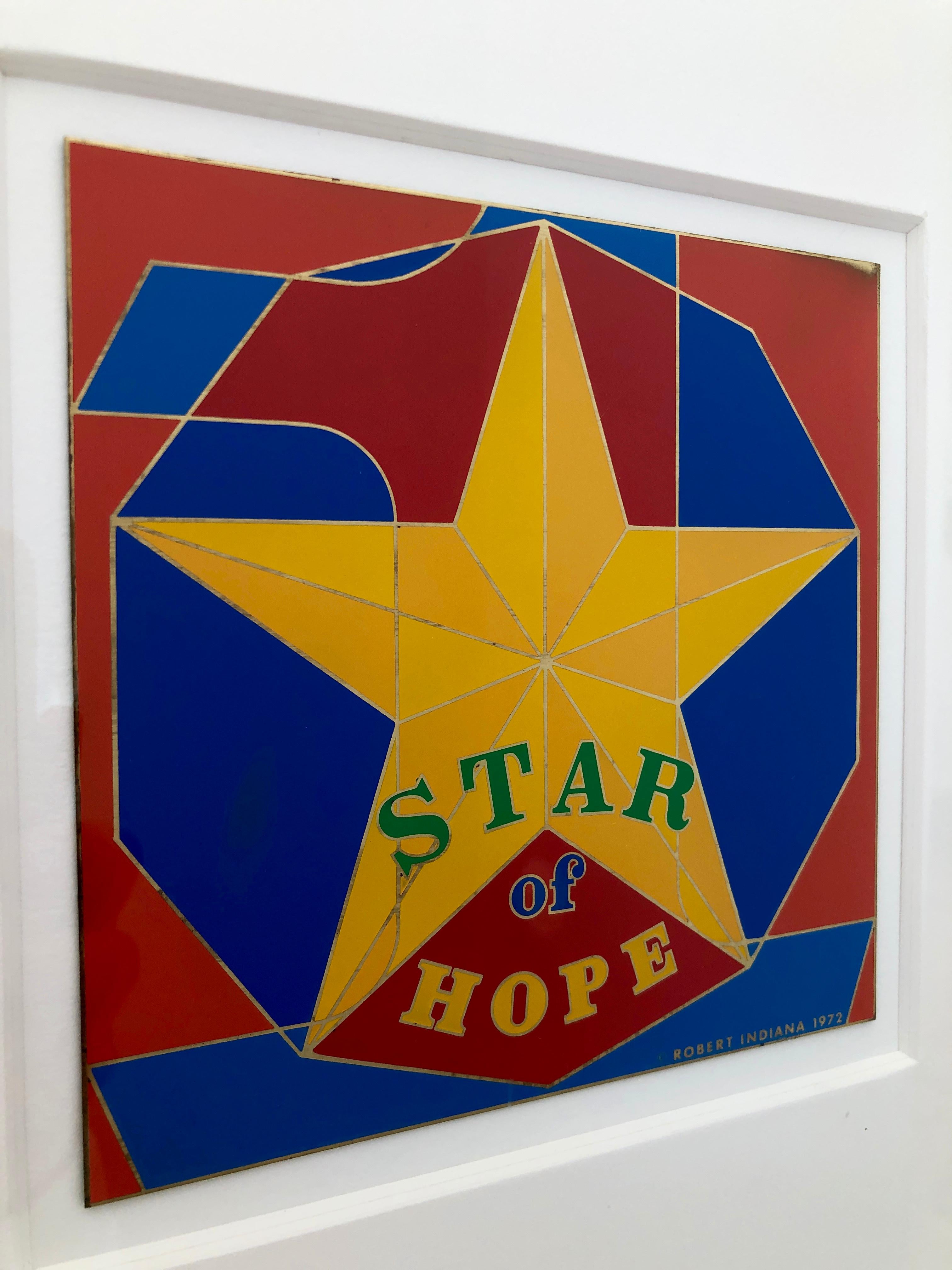 Offered is a framed in white midcentury Pop Art piece by Robert Indiana signed and dated with enamel on metal entitled, 