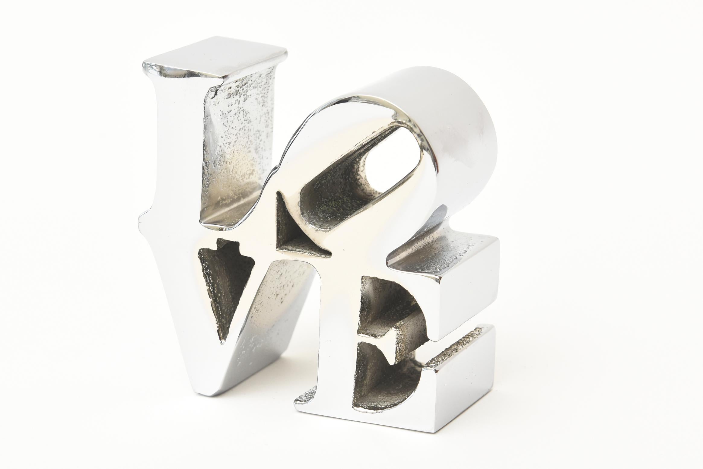 This iconic small Robert Indiana paperweight love sculpture is nickel-plated over the chrome. It is from the 1970s and was originally sold at MoMA in NYC and other various museum shops at the time. Robert Indiana as an artist and painter put himself