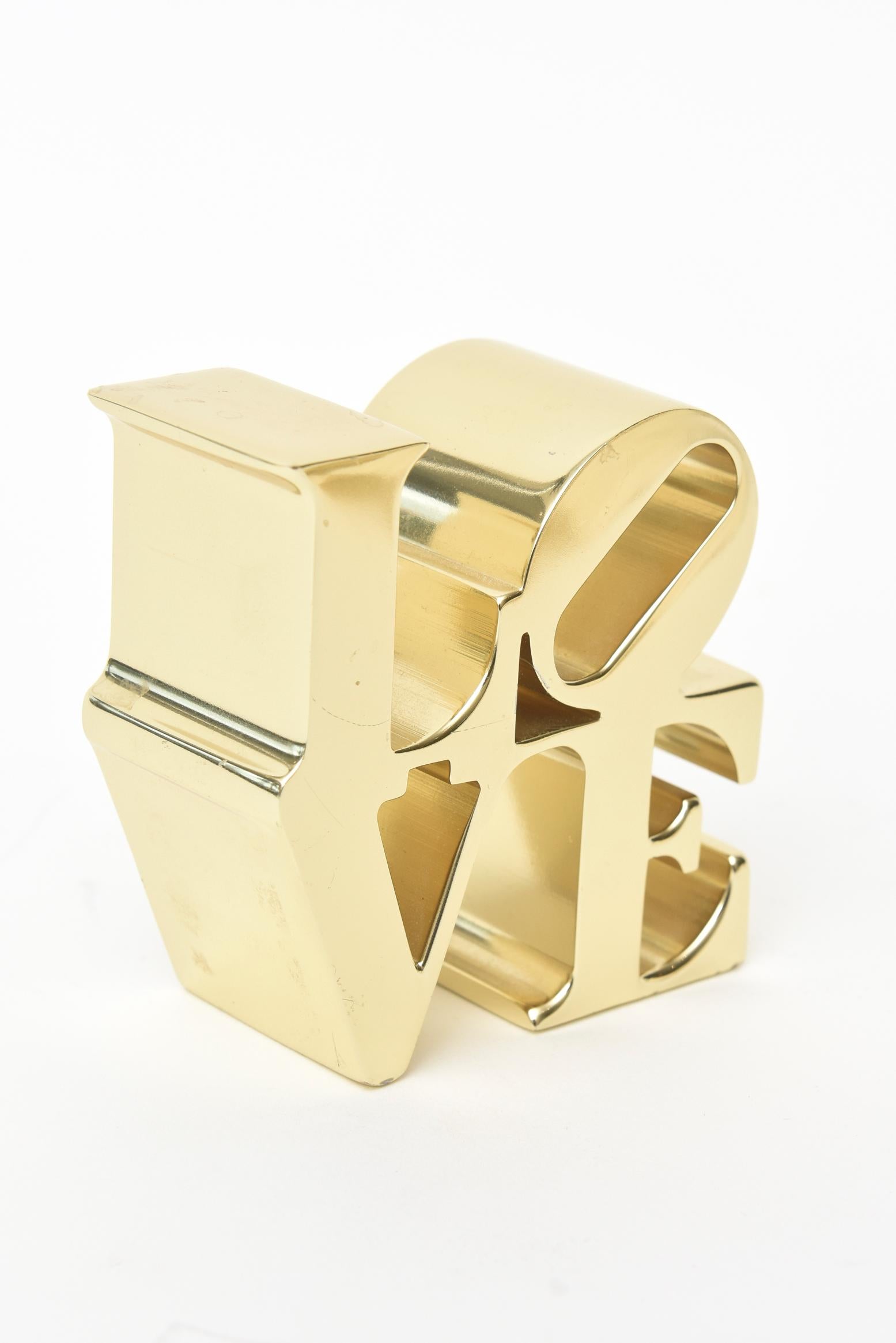 This iconic vintage small Robert Indiana brass LOVE paperweight sculpture is from the 1970s and was originally sold in museum stores at the time most notably MOMA in NYC. Great for desktop, console ensemble and cocktail table. This would make a