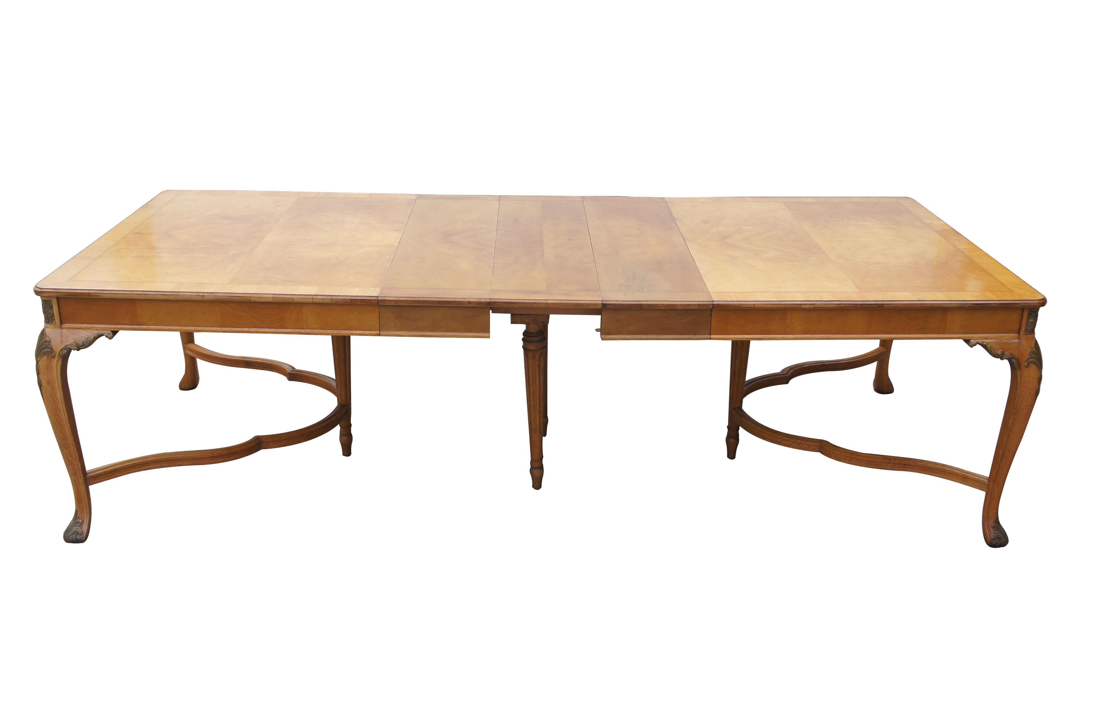 (1919-1953)
Irwin, Robert W. Co
Grand Rapids, Mi

An exquisite French walnut dining table by Robert Irwin Furniture Company. Elegantly designed with crotch walnut veneered top. Includes an inlaid band around the top, and acanthus carvings