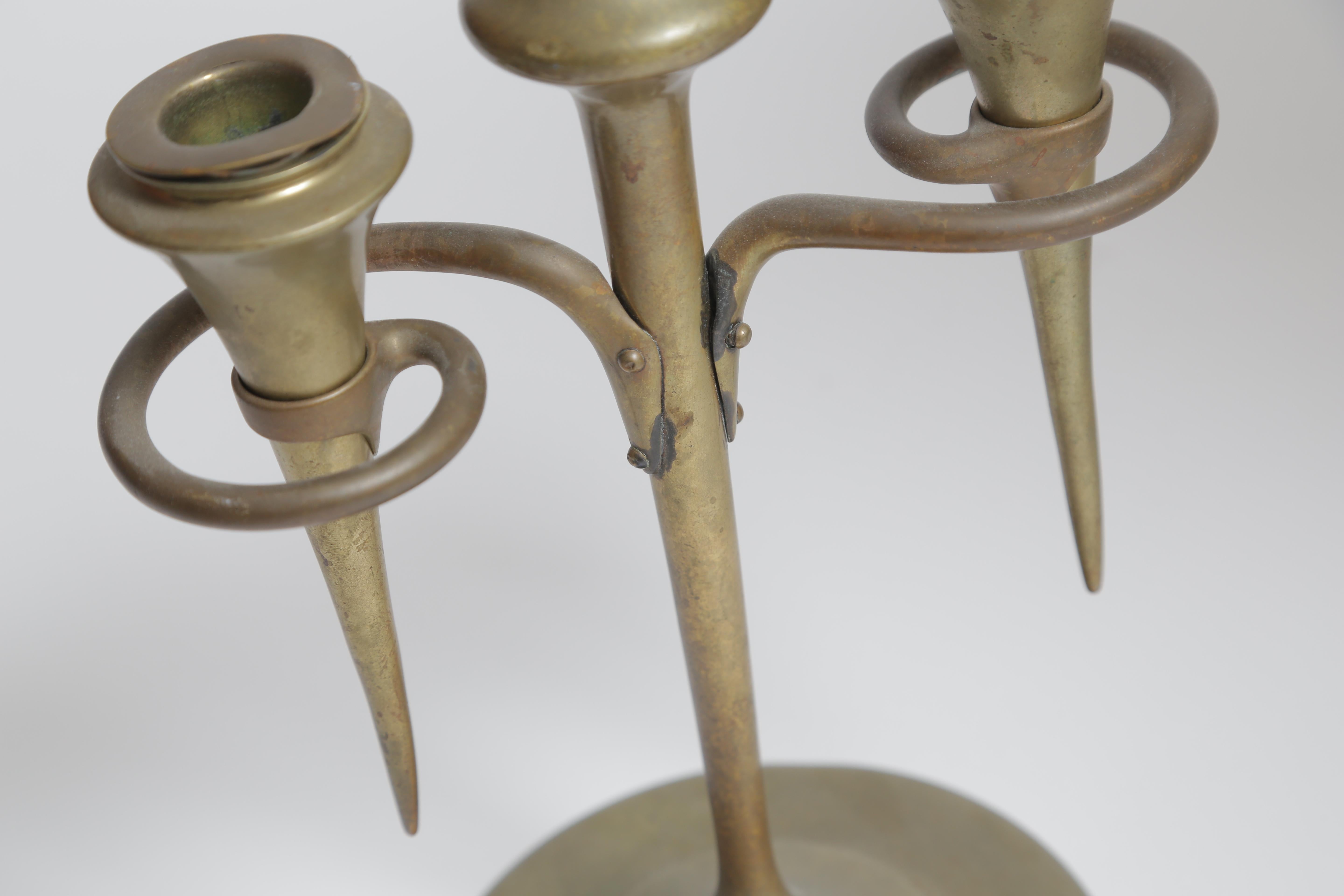 A solid brass candlestick with original bobeches.
Original patinated surface. Signed
An extremely forward l-looking design from the early 1900s.