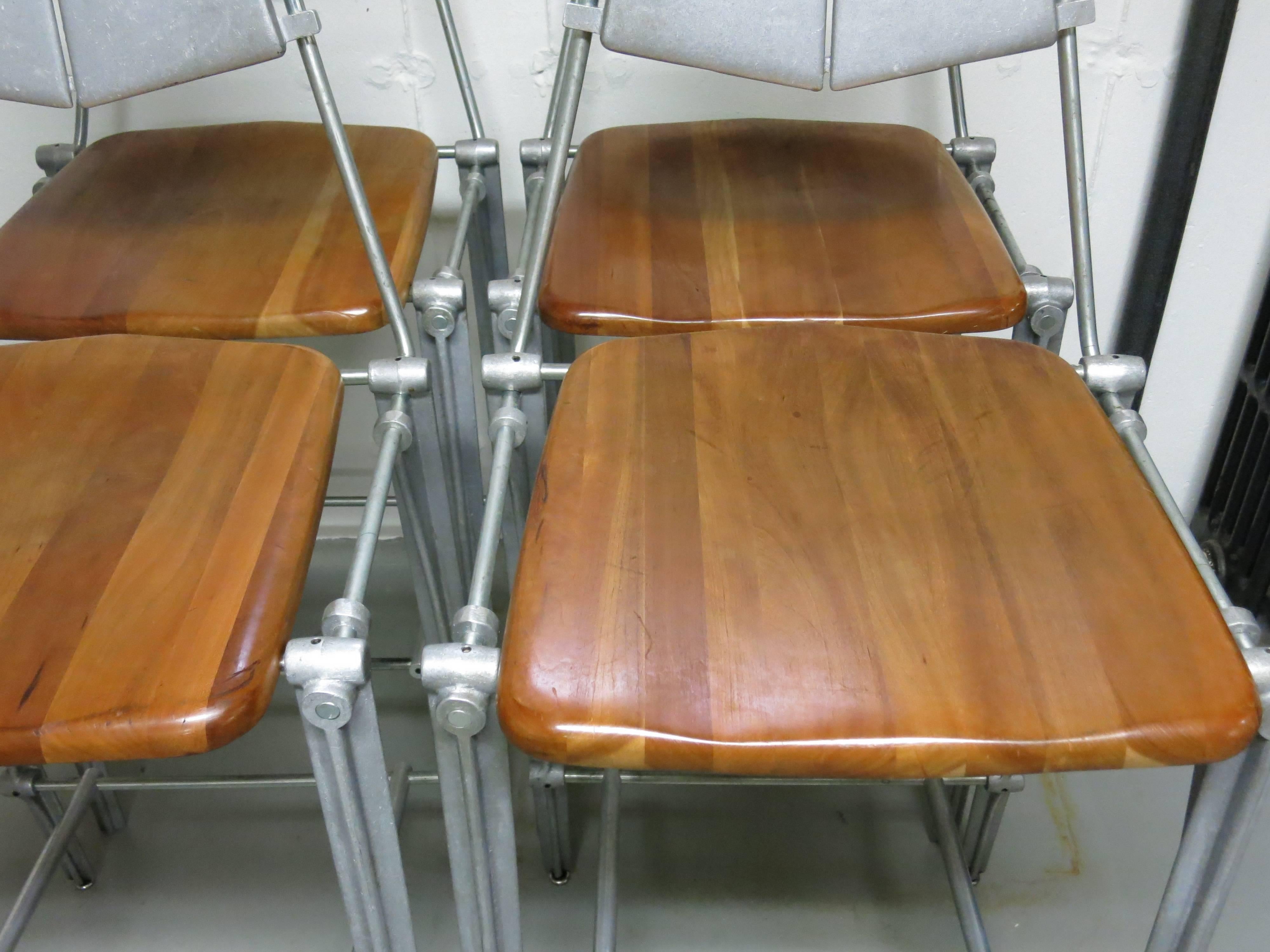 Nice set of 4 Robert Josten cast aluminum and maple bar stools.   A modern industrial style stool from the California designer dating from the 80's.  Seats are at a custom height of 27