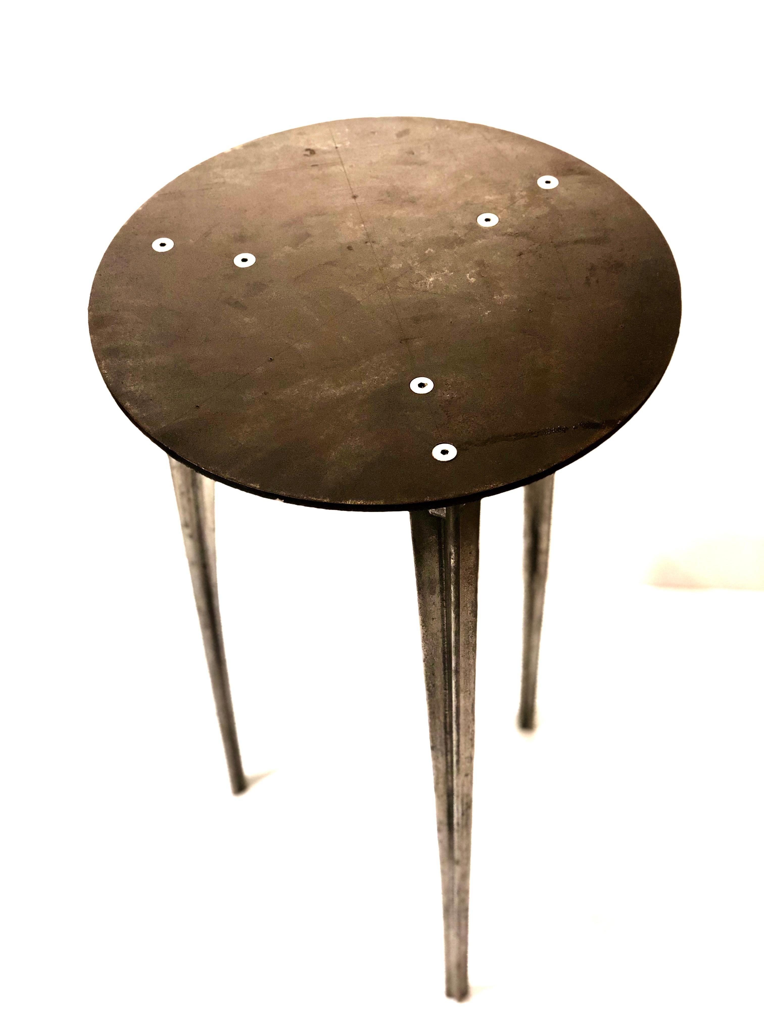 Rare tall cocktail table by Robert Josten solid raw patinated steel top with cast aluminum legs circa 1980s , all original condition very unusual to see this table , his designs are scarce and this one its very rare perfect for a corner table.