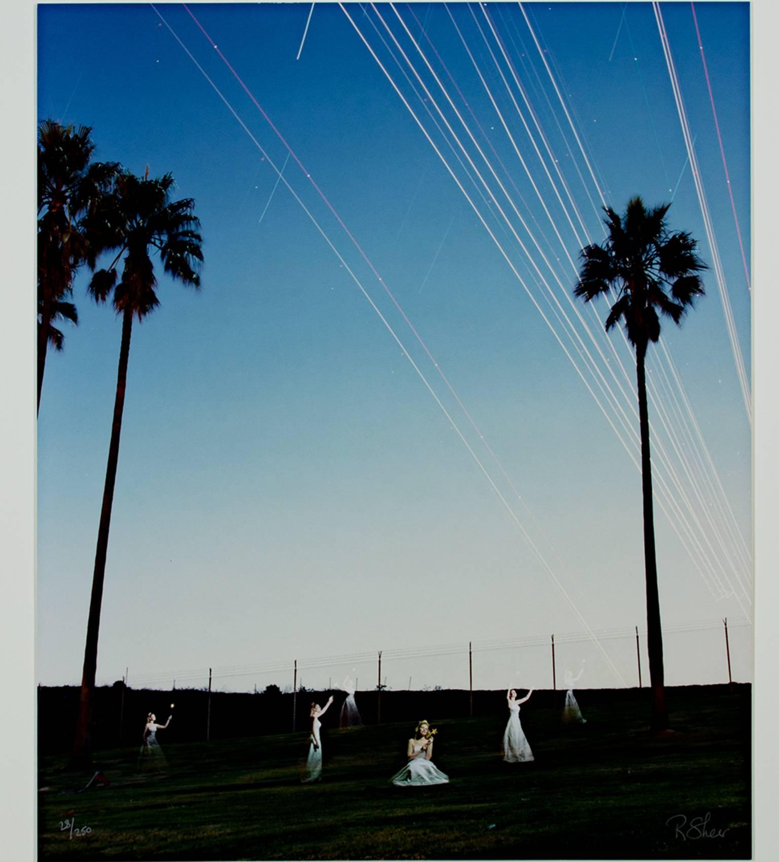 "The Fairy Princess Levitating Planes Into the Night Sky at LAX" is a long-exposure photograph by Robert Kawika Sheer. The artist signed this piece in the lower right and editioned it in the lower left. Edition: 28/250. It depicts multiple views of