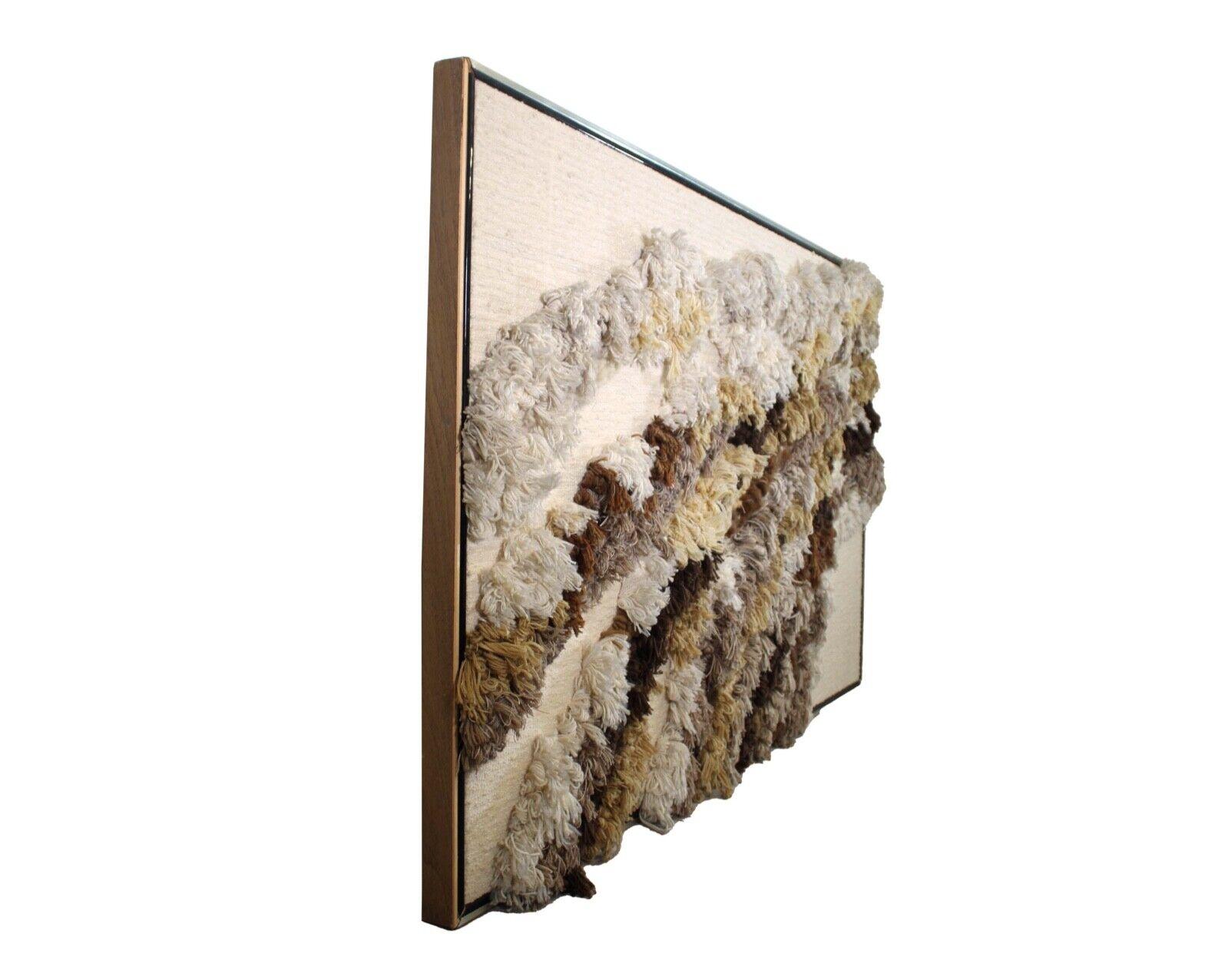 A magnificent, framed, handwoven, abstract fiber wall art made with wool yarn, by Robert Kidd, circa 1970s. This textural art piece makes a unique statement artwork for a modern or contemporary designed space. Dimensions: 73