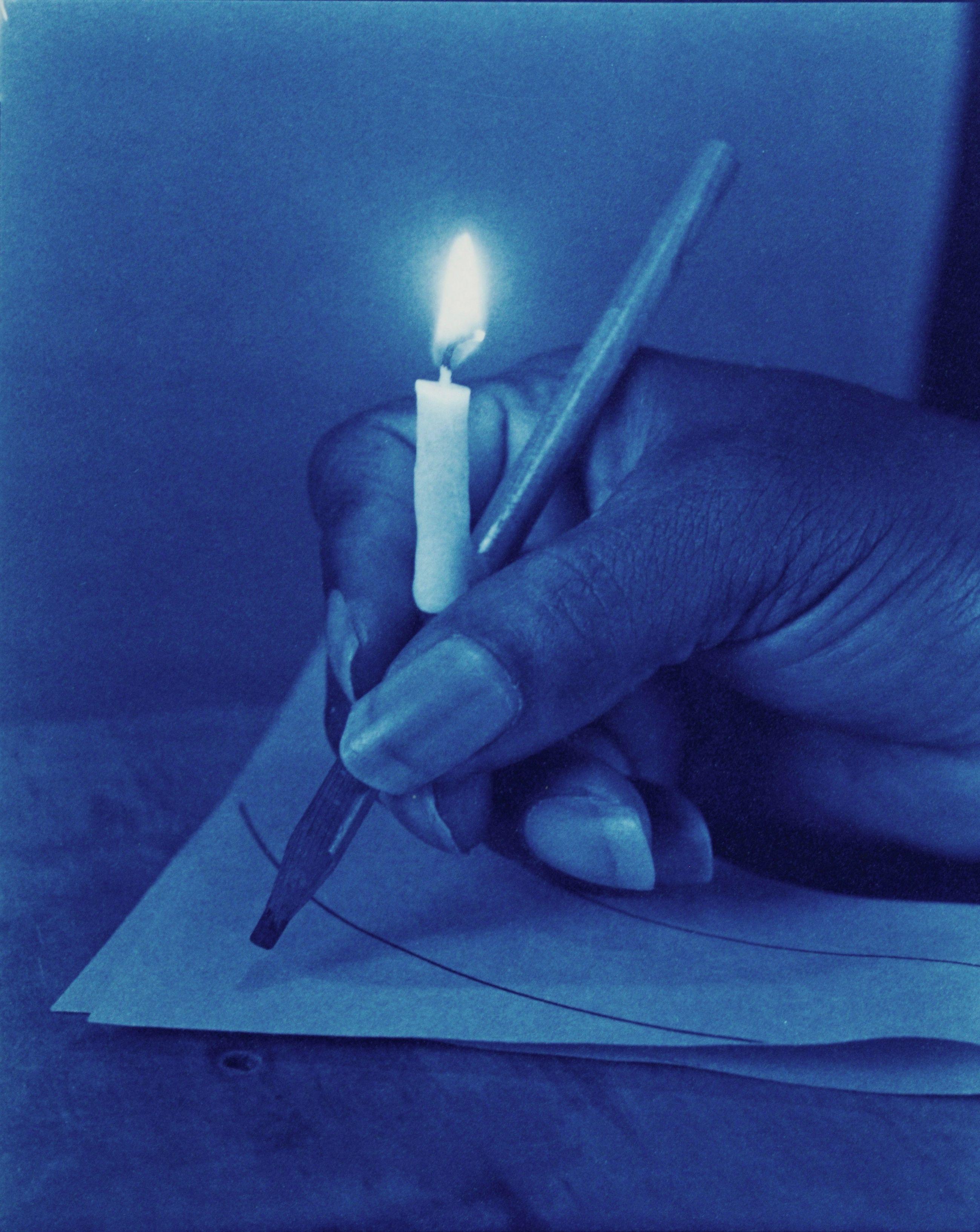 Robert Langham Color Photograph - Illuminated Manuscript - Surreal blue cyanotype hand & candle still life
