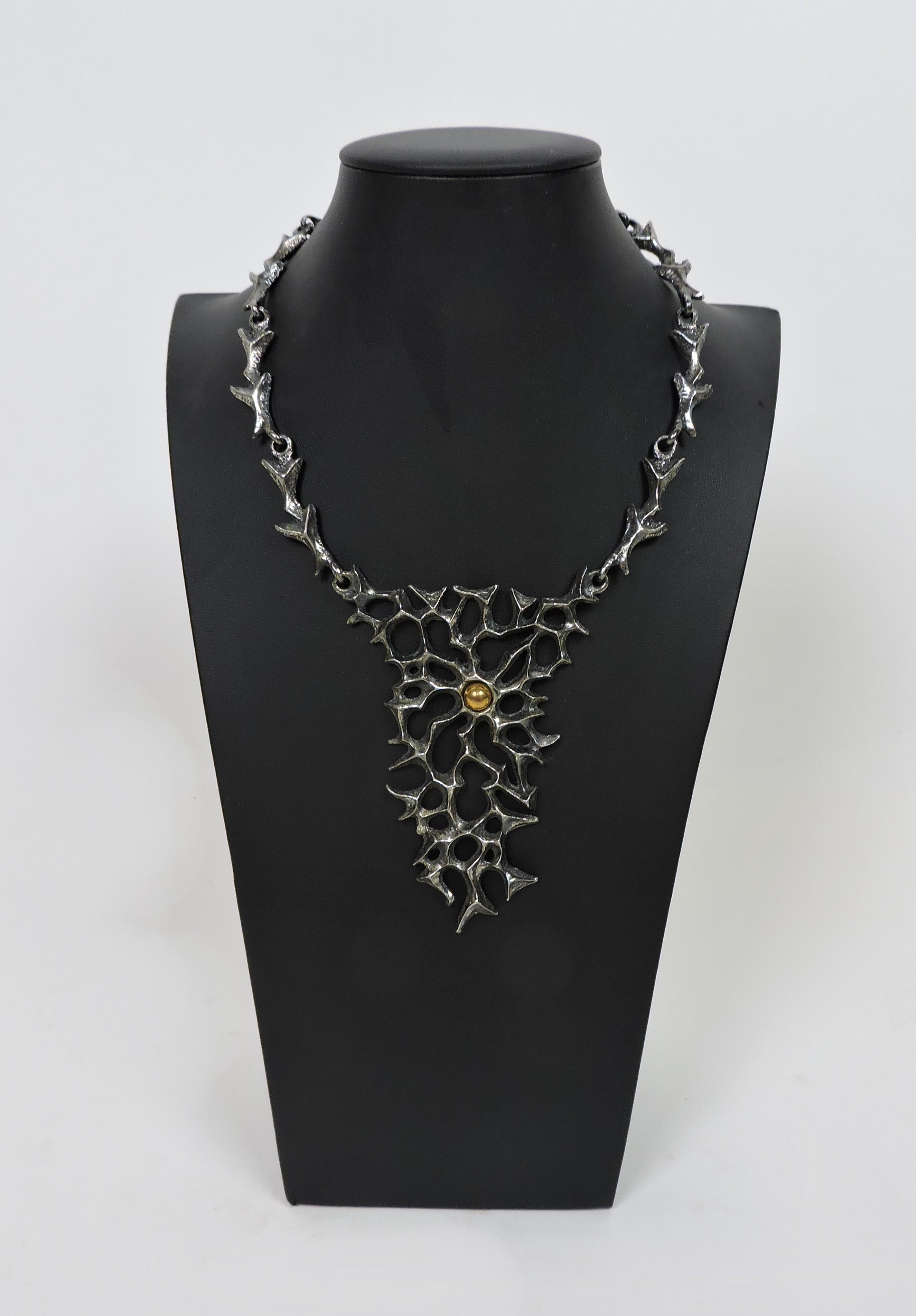 Striking large and dramatic brutalist style sculptural necklace by acclaimed Canadian jewelry artist, Robert Larin. Made of hand cast pewter and signed Robert Larin on the back.

From Bidsquare:
Robert Larin was creating pewter jewelry as early as