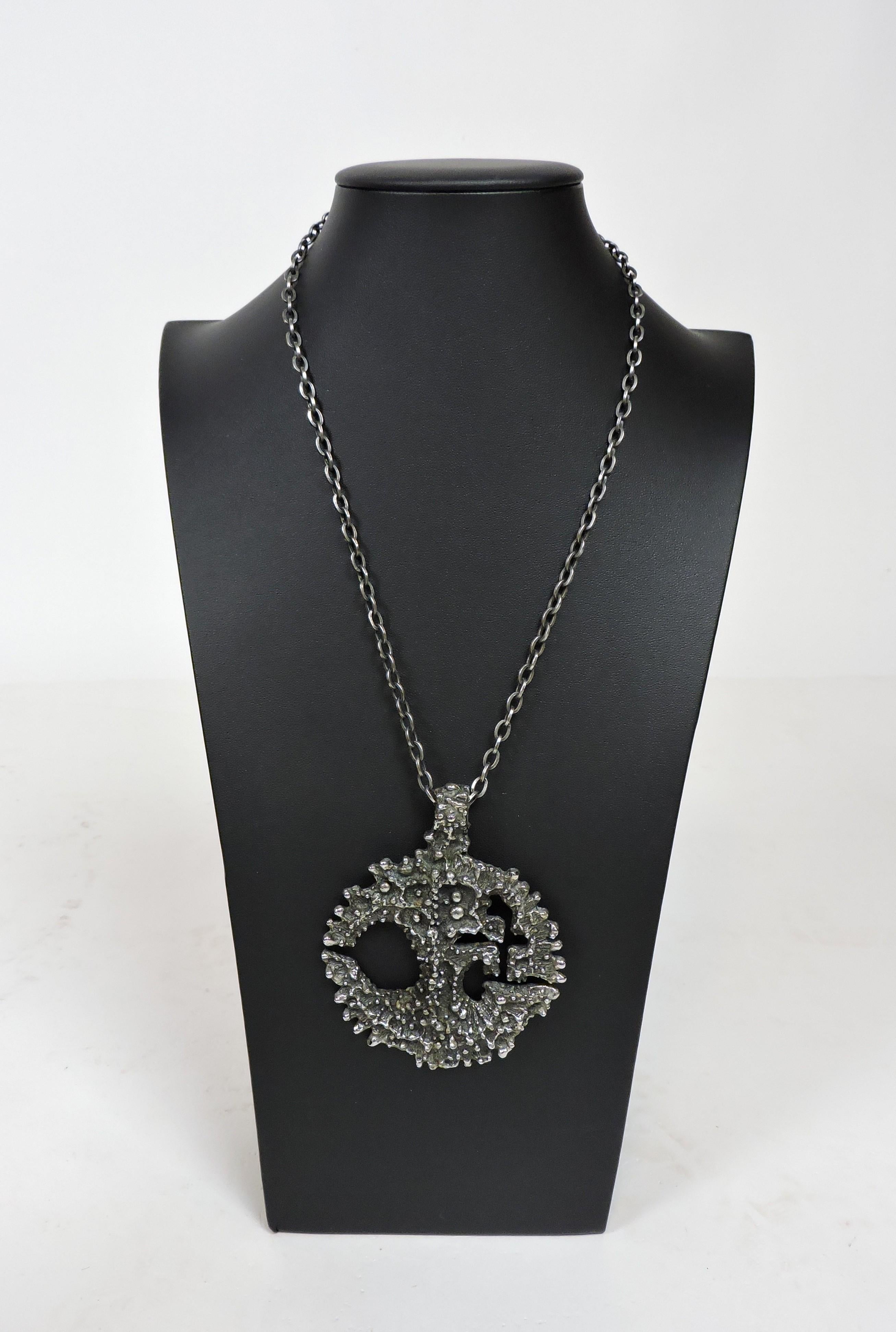 Striking large and dramatic sculptural brutalist style pendant necklace by acclaimed Canadian jewelry artist, Robert Larin. Made of hand cast pewter and signed R. Larin on the back, this also has the original chain. The pendant size is 2.75 inches