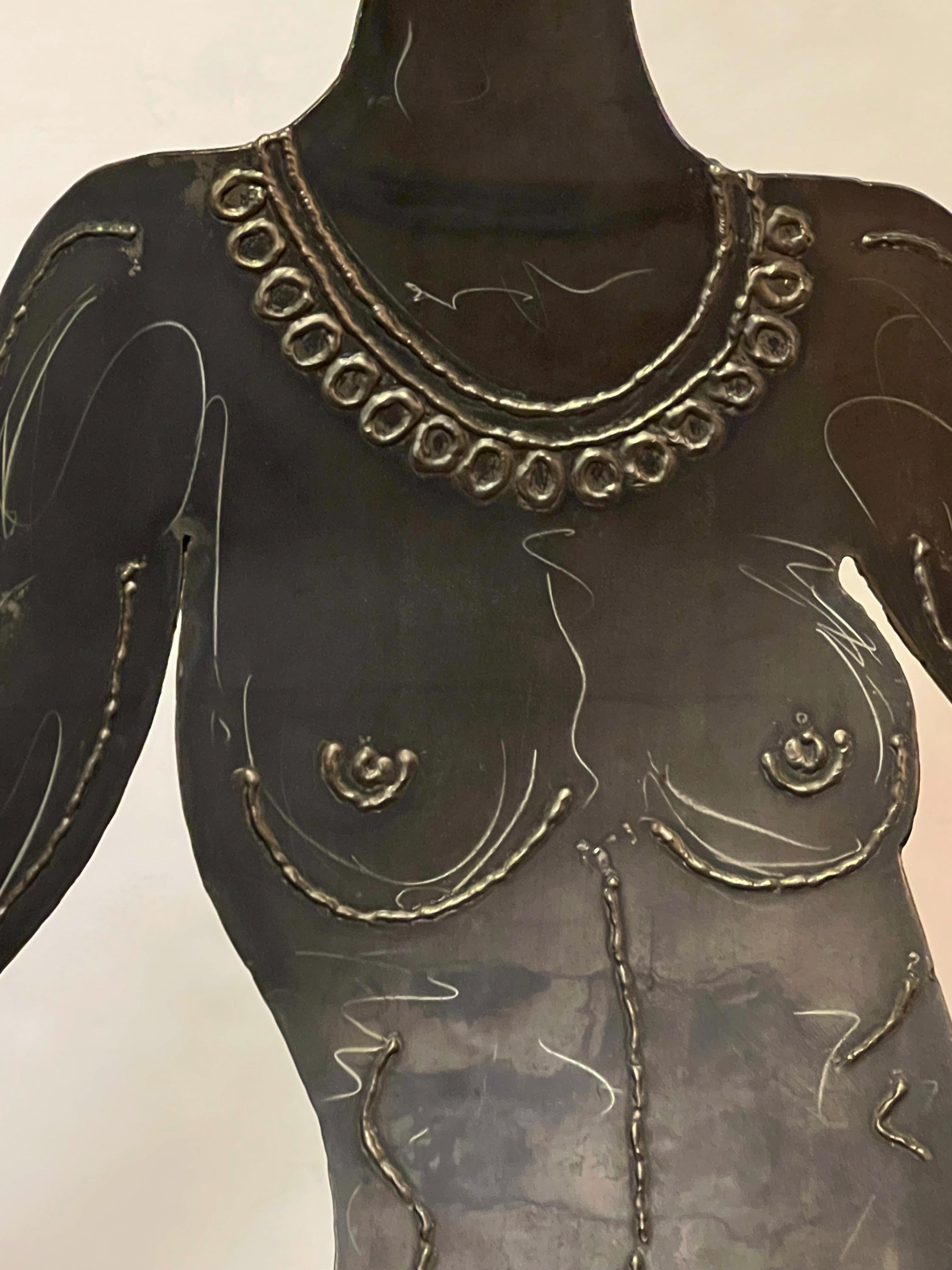 In front of Robert Lee Morris's Beverly Hills store in 1993 stood this unique life-size brass sculpture of a nude woman with a bob cut, dressed only with luxurious jewelry. The sculpture named 