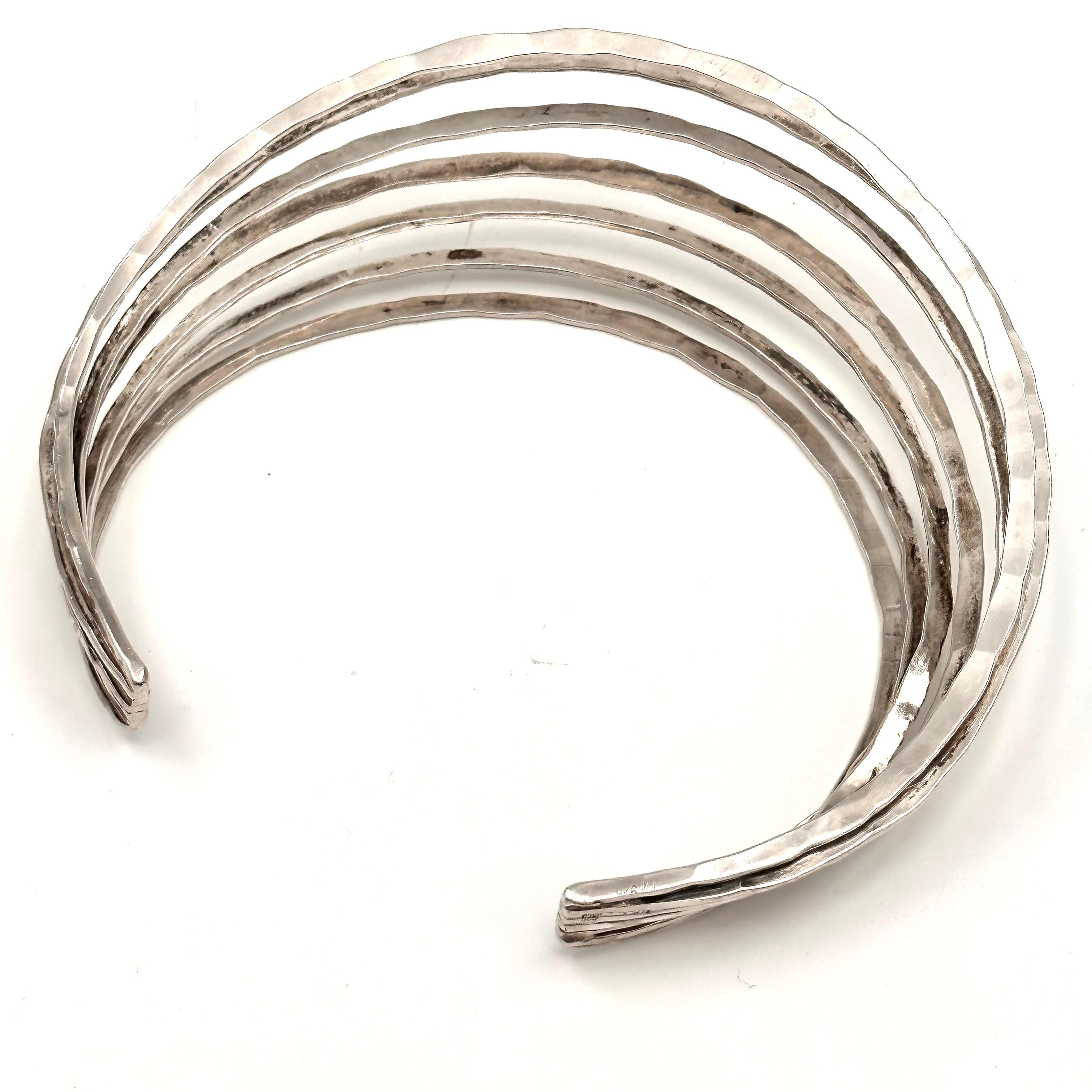 Forged sterling silver with all the gorgeous hammer marks, is what makes this impressive collar sparkle so. Robert Lee Morris is known for show stopping jewelry, whether on the runway or in the pages of fashion magazines. This handsome silver collar