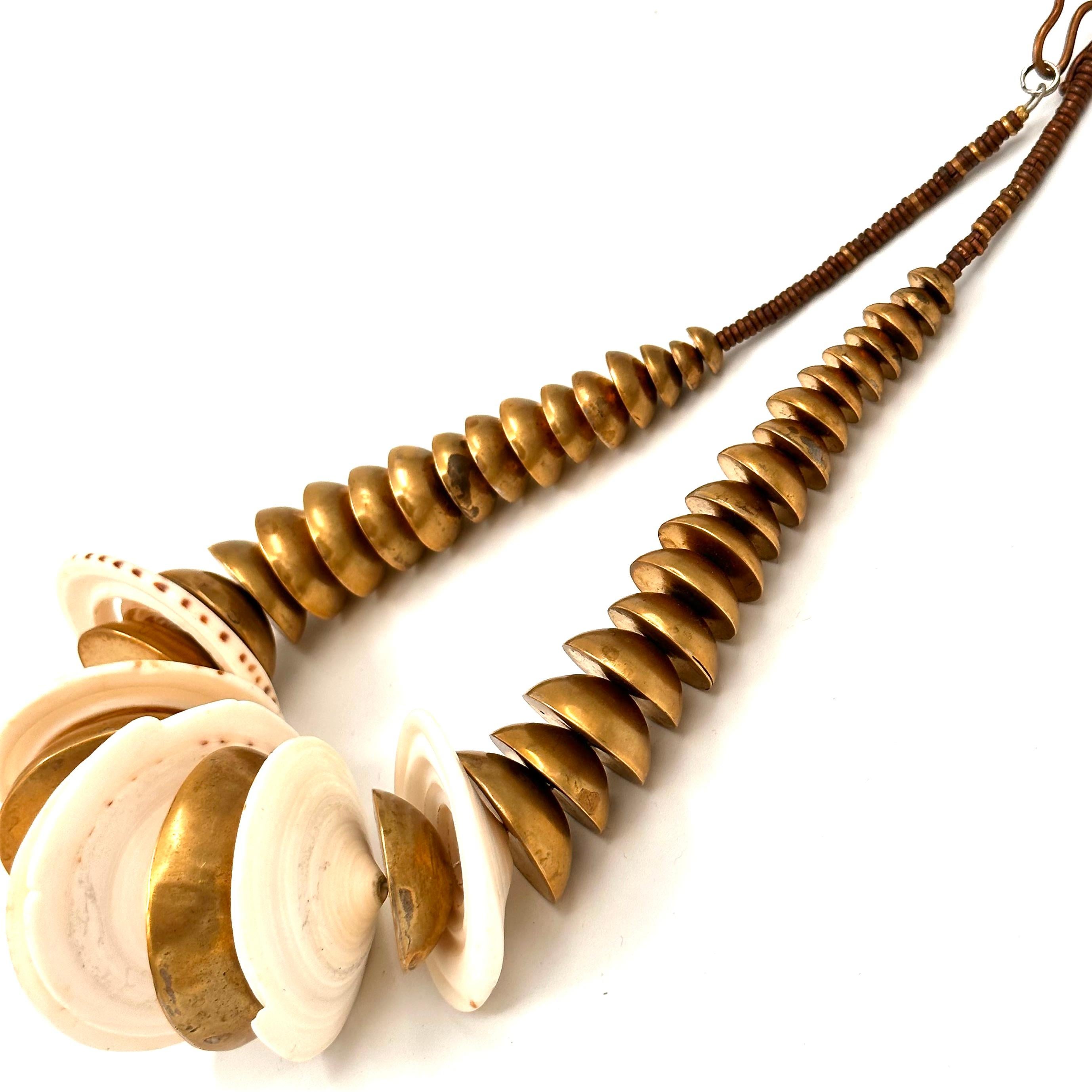 Robert Lee Morris Brass and Shell Nautilus Necklace created very early in his career in 1975. This powerful  bold nature of this statement necklace is part of a series called the Nautilus Series, whereby variations of this theme were very important