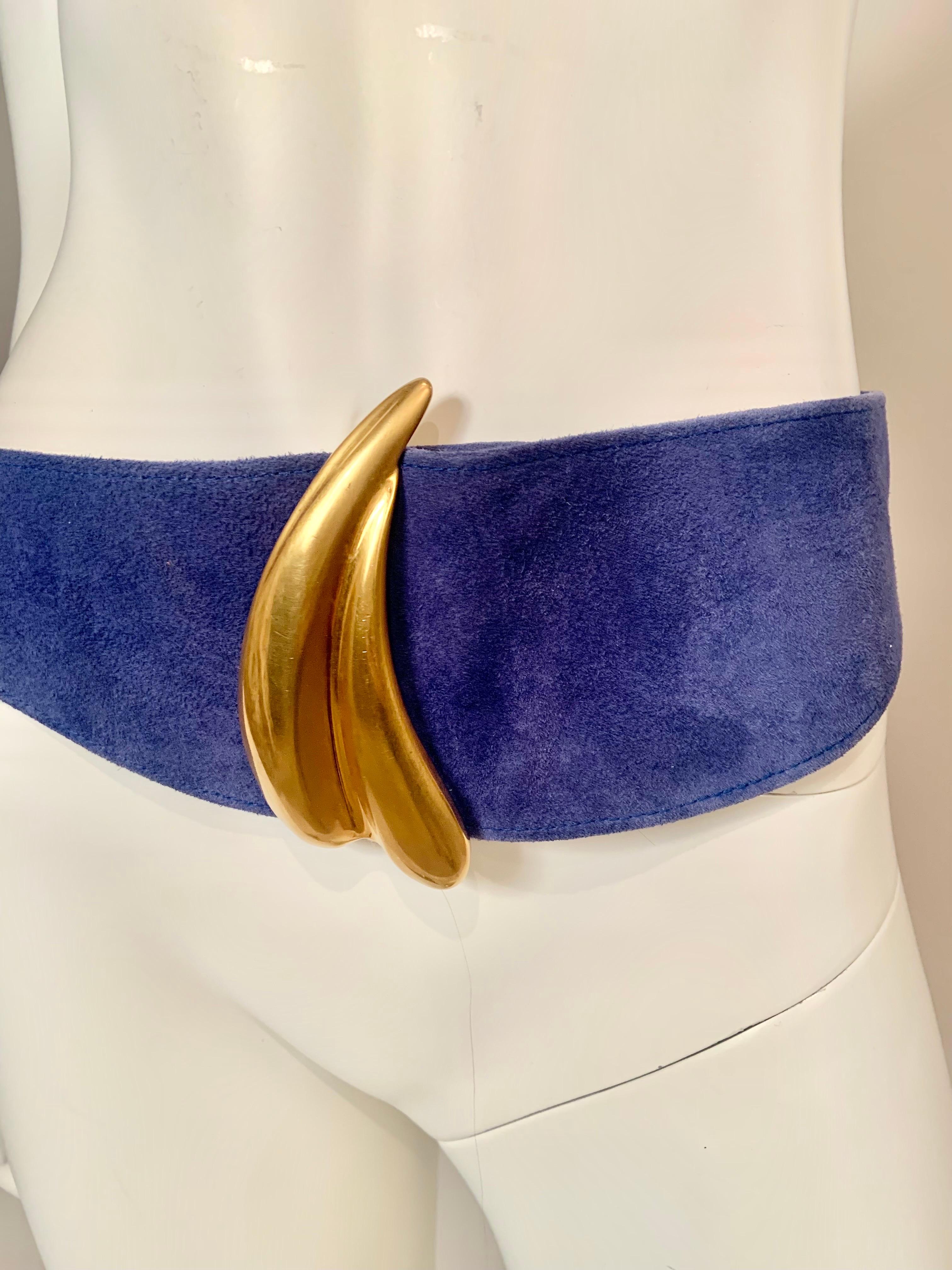A dramatic Robert Lee Morris buckle in gold toned metal adorns a French blue suede belt from Donna Karan.  The belt is quite wide in the front and narrow in the back. I have shown it worn in two ways, this gives you a different, heart shaped look