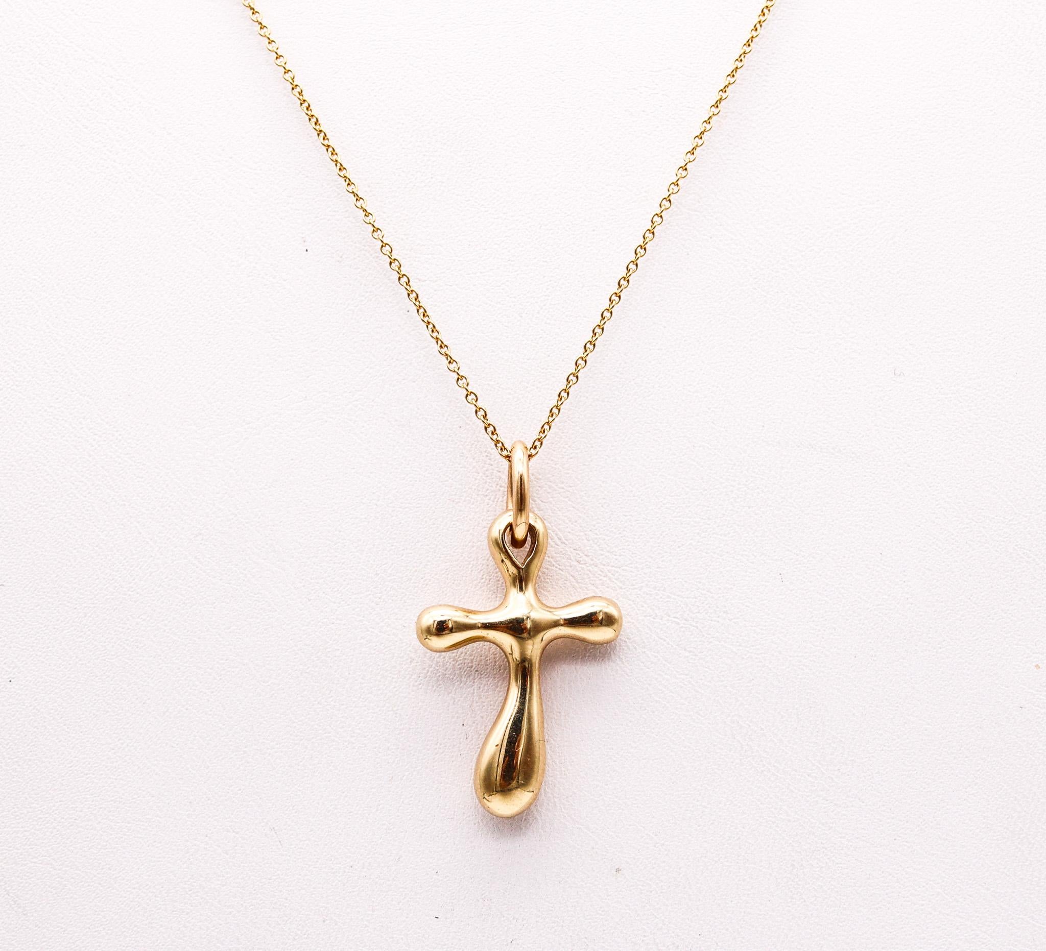 Cross pendant designed by Robert Lee Morris.

Beautiful sculptural cross, created at the studio of Robert Lee Morris. This modernist cross was crafted with free forms sinuous and wavy shapes in solid yellow gold of 14 karats with high polished