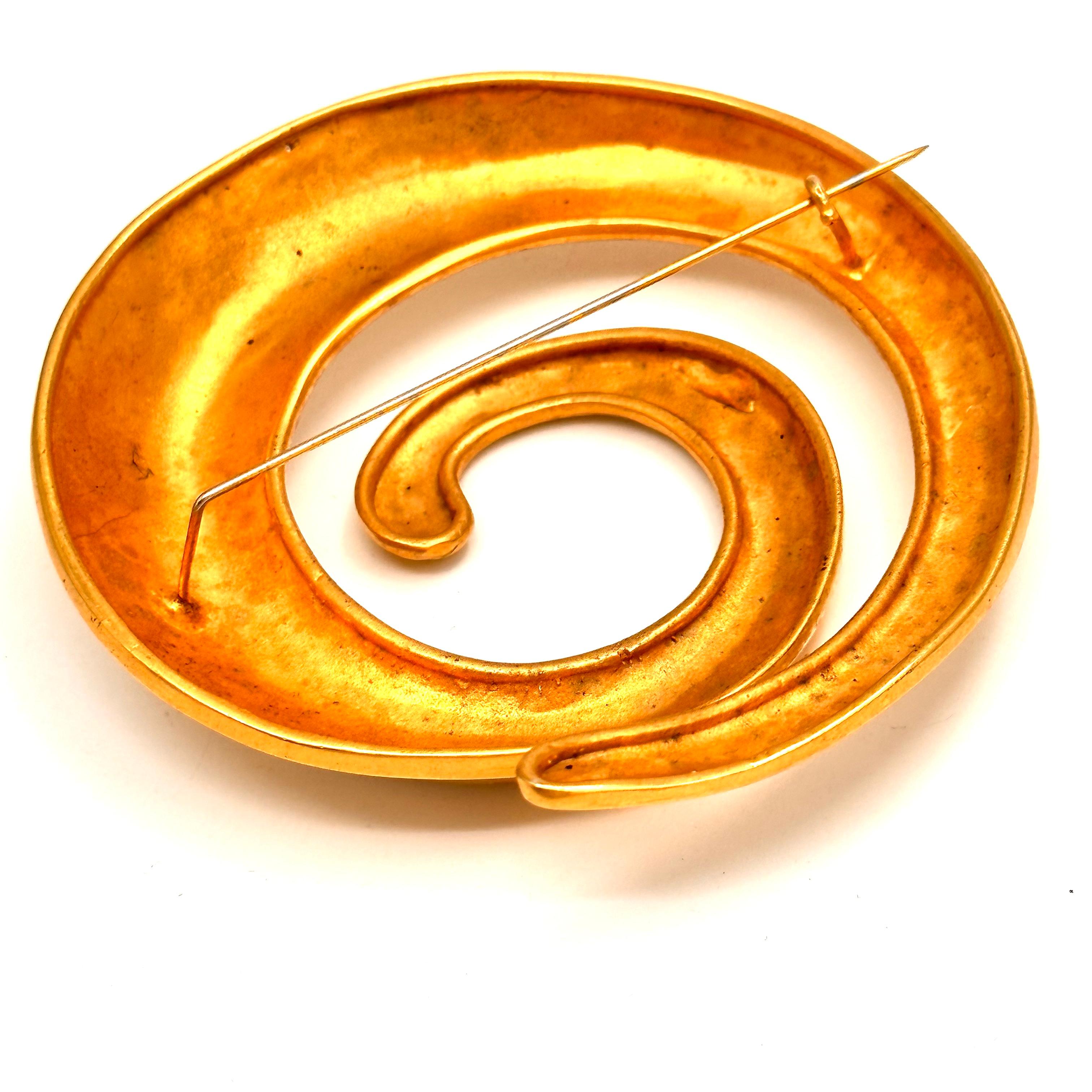 This dramatic coil of matte 24k gold plated on brass, is an iconic Robert Lee Morris style, it is his unique vocabulary of forms that are all family members to the organic movement. Forged into a swollen curvaceous form this brooch was part of a