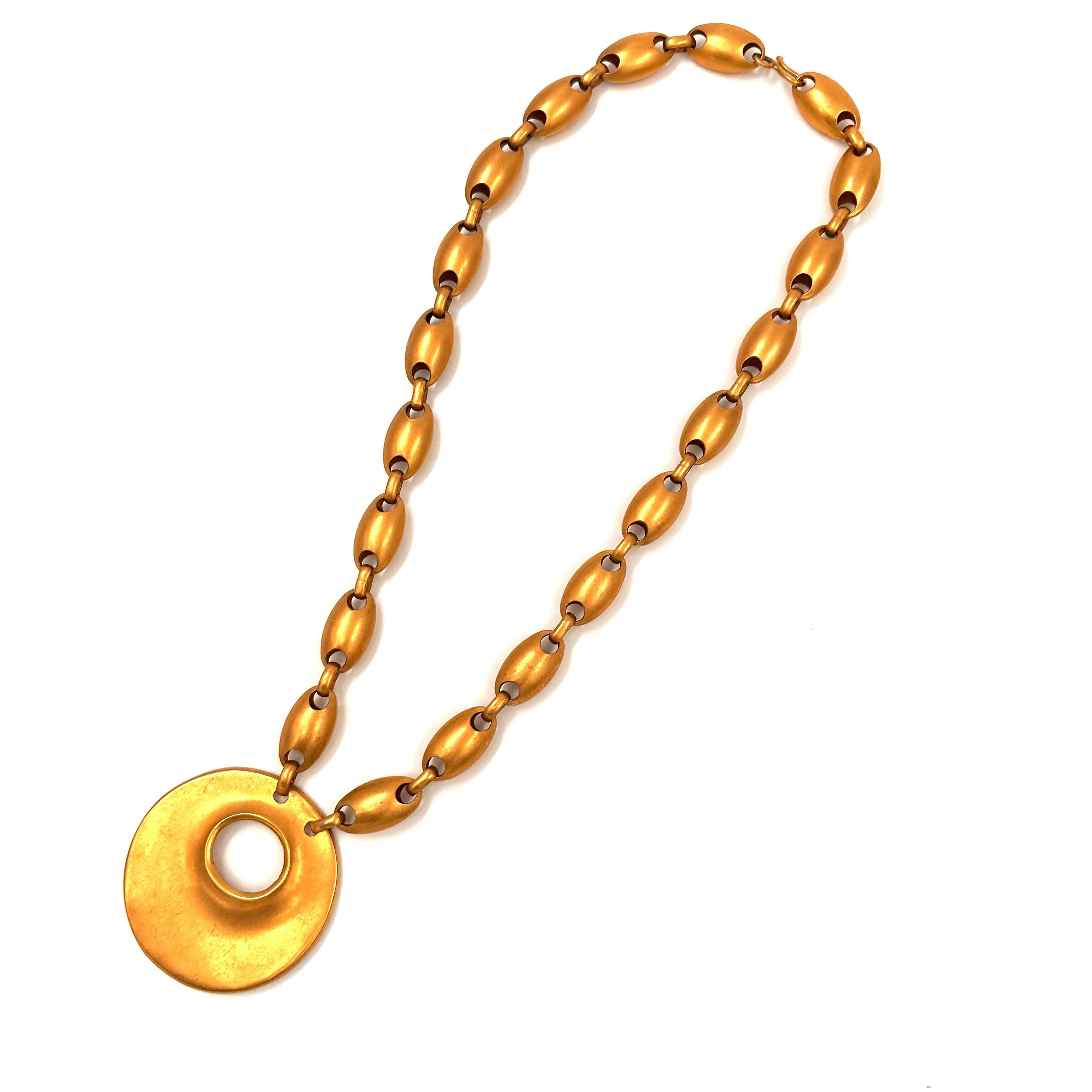 Robert Lee Morris Long Gold Plated Egg Chain Necklace with Crater Pendant, created in 1987. During a period when when Morris was creating Egg themed jewelry, including using soft rounded pebbles there was a push for bigger volume with less weight in
