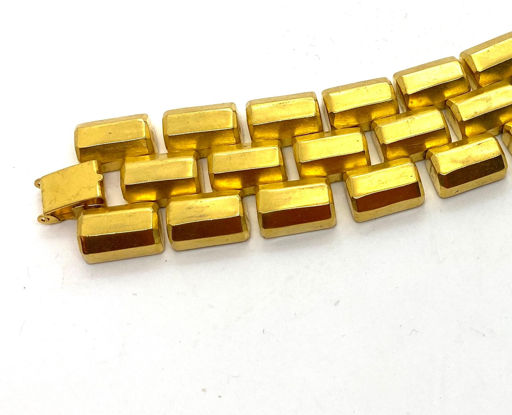 This glamorous wide link bracelet is iconic of the Bold Gold trend that was created by Robert Lee Morris and Donna Karan during the height of the 1980's. Inspired by the brick-lay construction (using rich 24k gold plated brass castings), from the