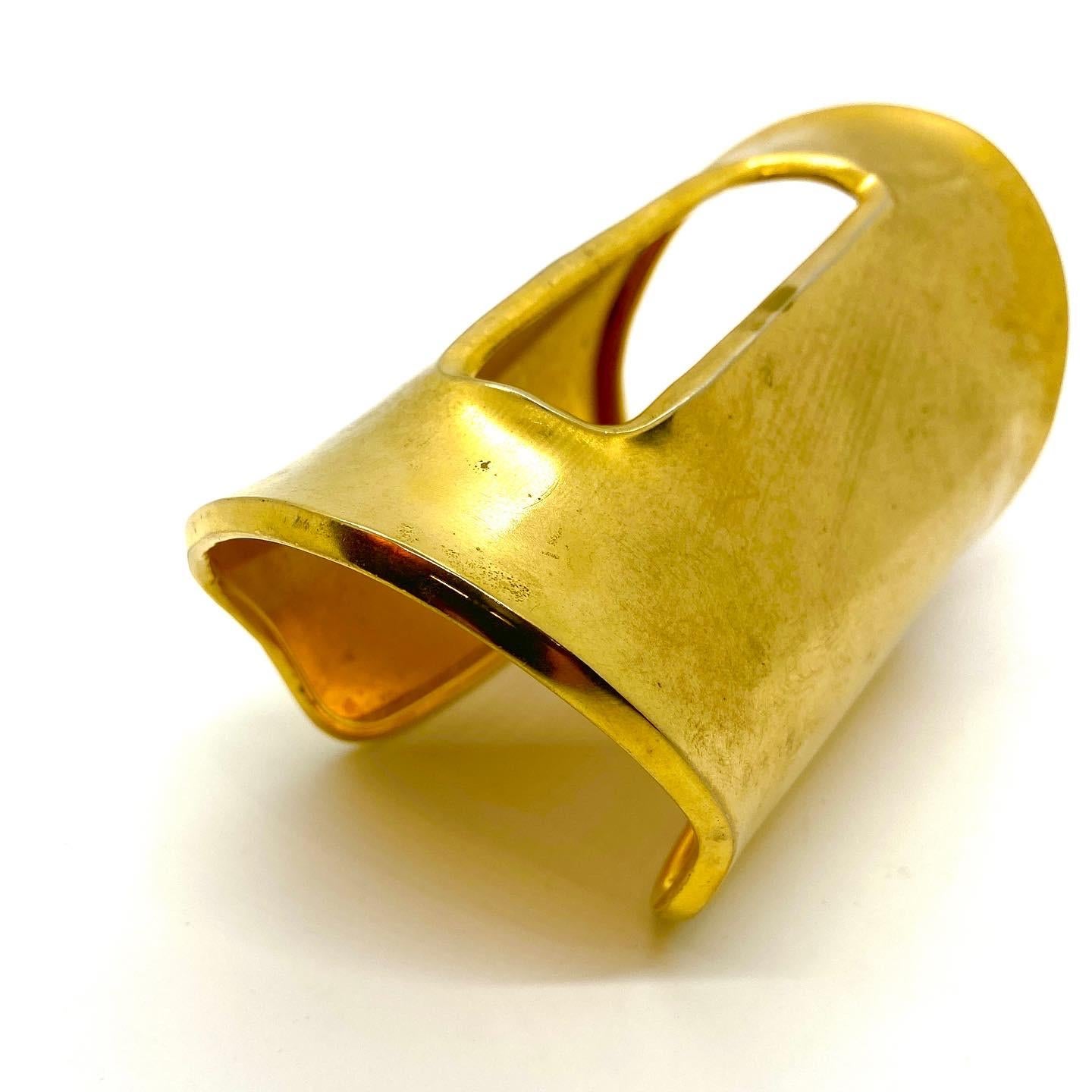 This one of a kind spectacular and dramatic matte gold plated cuff is a statement bracelet. Created as a publicity piece, it fed into the voracious appetite of the fashion magazine editors for bigger and more stunning jewelry during the period of