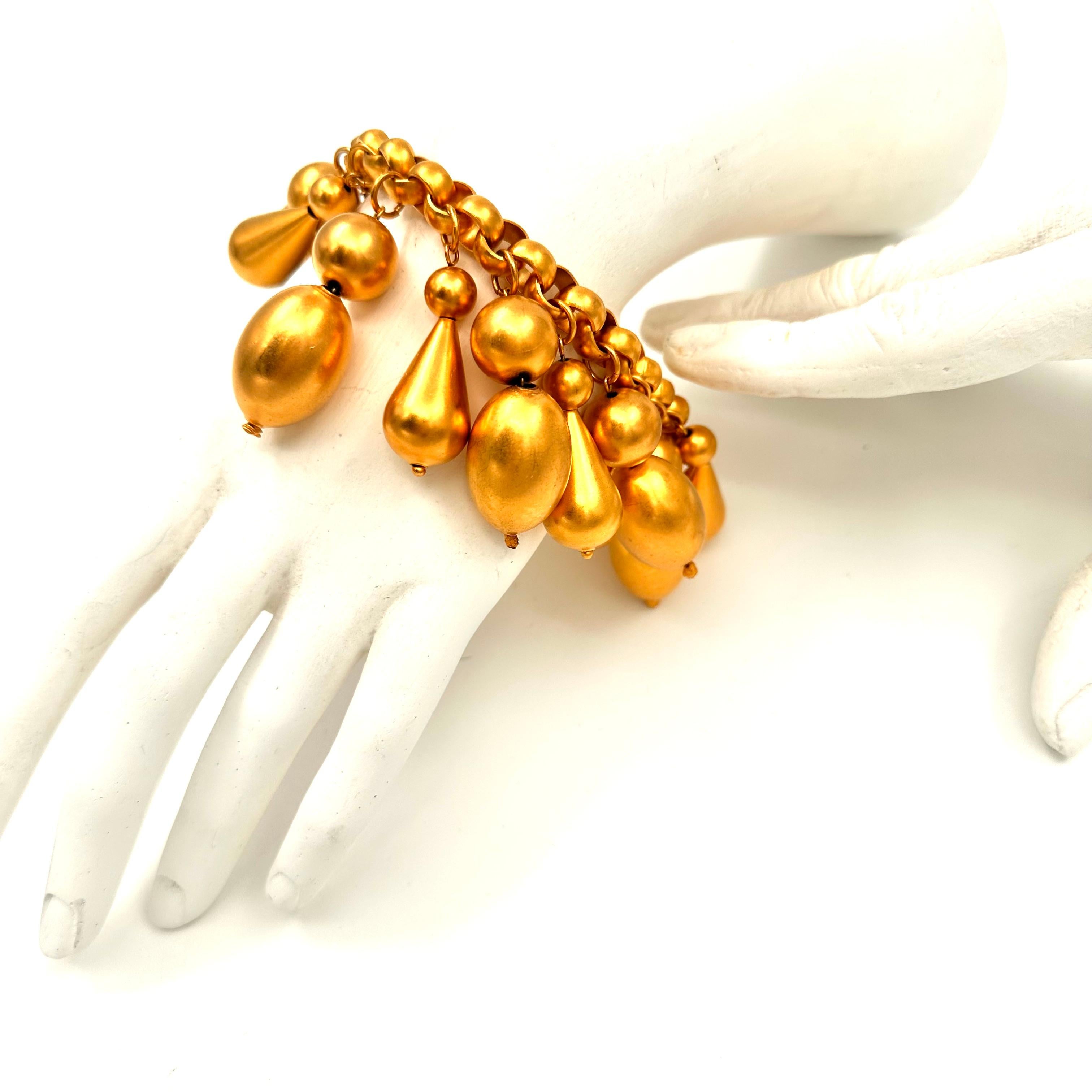 Robert Lee Morris Runway Collection All Gold Charm Bracelet for Donna Karan, created for a resort show in 1987. This spectacular runway bauble, is a splash of gold bubbles, large and dangling off a wide roll chain bracelet. the gold plated brass is