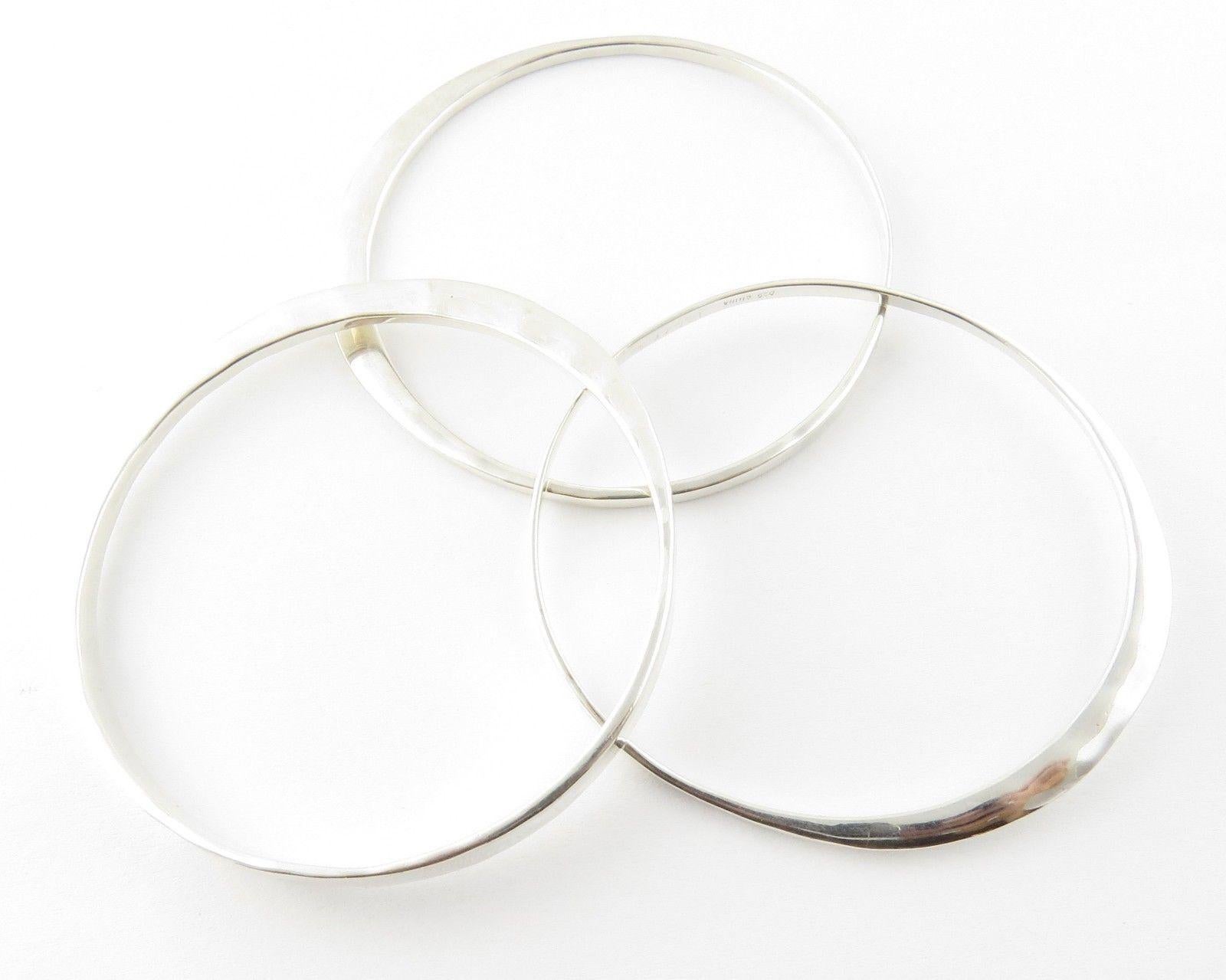 Robert Lee Morris Set of 3 Sterling Silver Hammered Bangle Bracelets

This is a set of 3 beautiful sterling silver hammered bangle bracelets by Robert Lee Morris.

Measurement: Approx 7 3/4 inches.  Each measure approx. 2 1/2 inches across the
