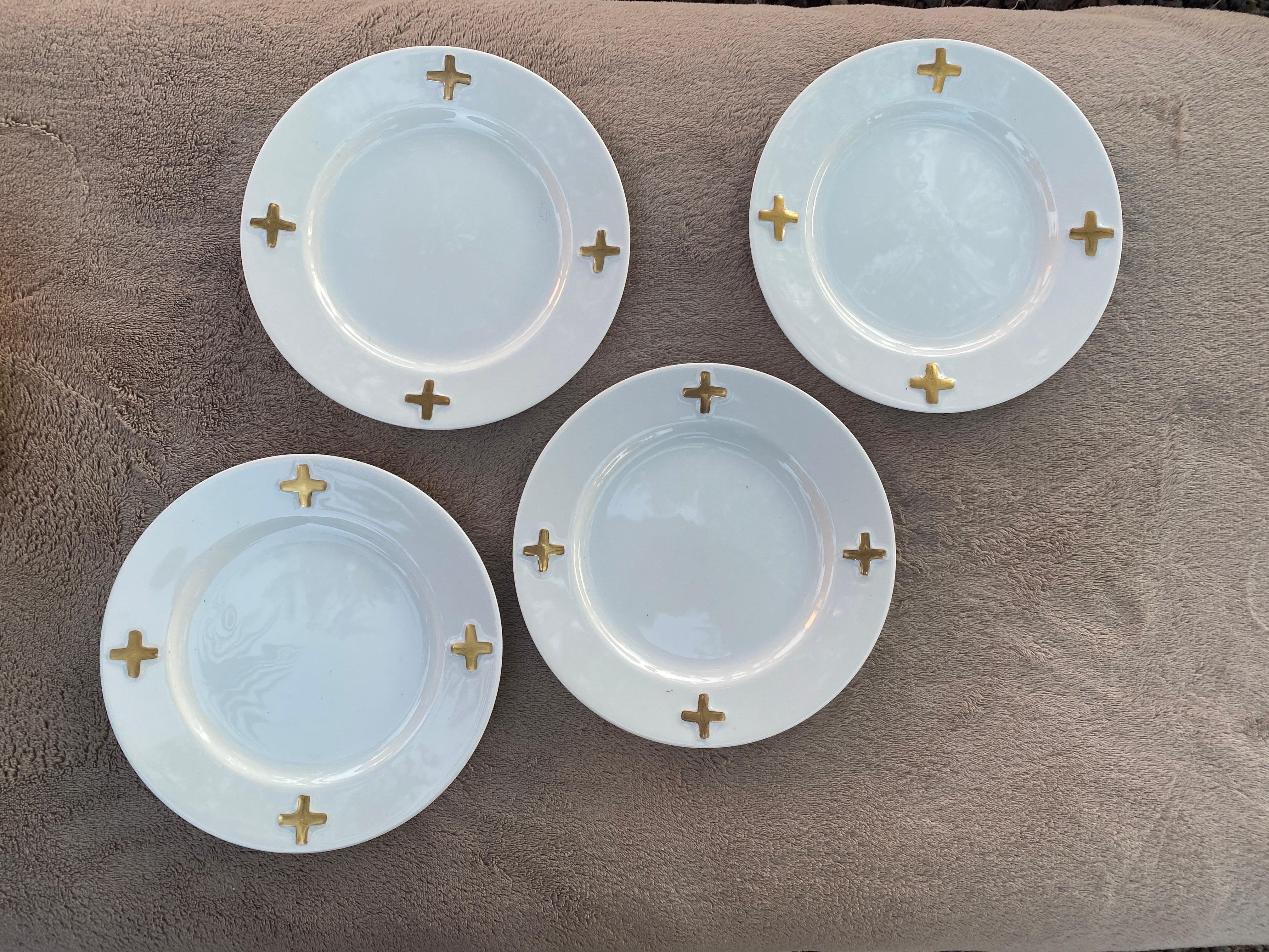 This set of dinnerware lunch plates were designed by the legendary jewelry and fine art designer, Robert Lee Morris for Swid Powell. The pattern name is called Camelot and is a chic, modern design of shiny white with 4 metallic gold crosses. It is