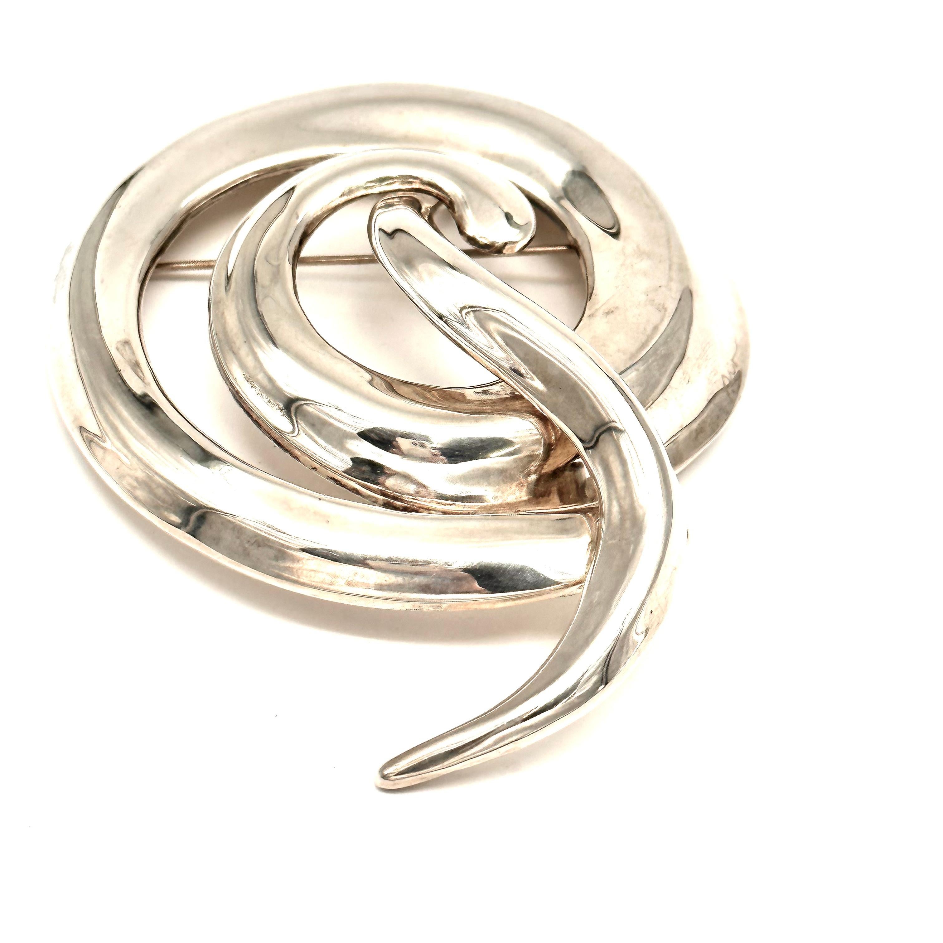 Created for a Donna Karan fall collection 1987, this large and impressive brooch is iconic for Robert Lee Morris and for Donna Karan, due to the unmistakable organic flow of the design. the spiral is intercepted by another curving worm like form,