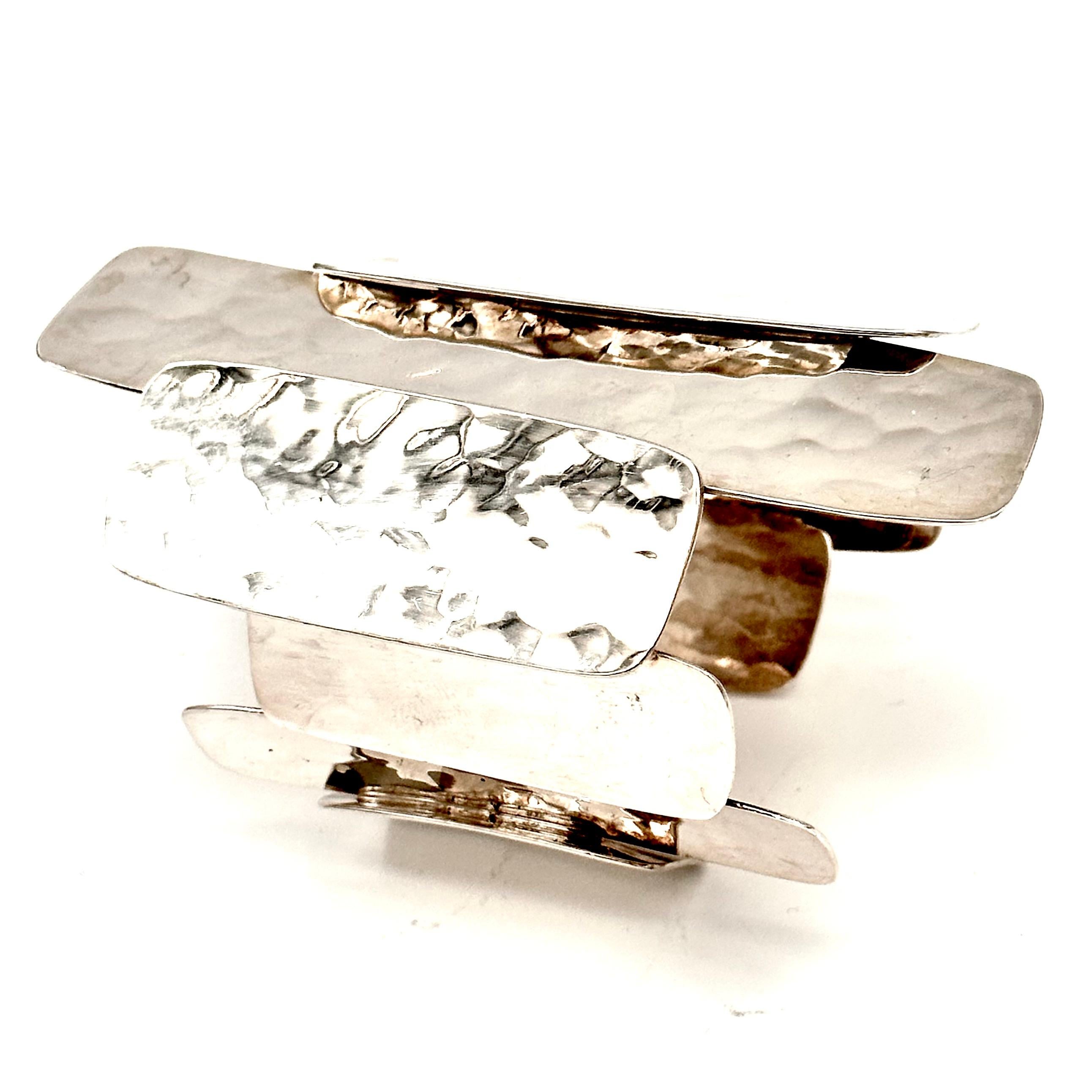 One of a kind Stegosaurus collection cuff, created with forged panels of sterling silver sheet. Easy to slip on to any size wrist, as the piece is flexible. The dramatic scale and hammered finish makes this piece a dazzling showstopper and statement