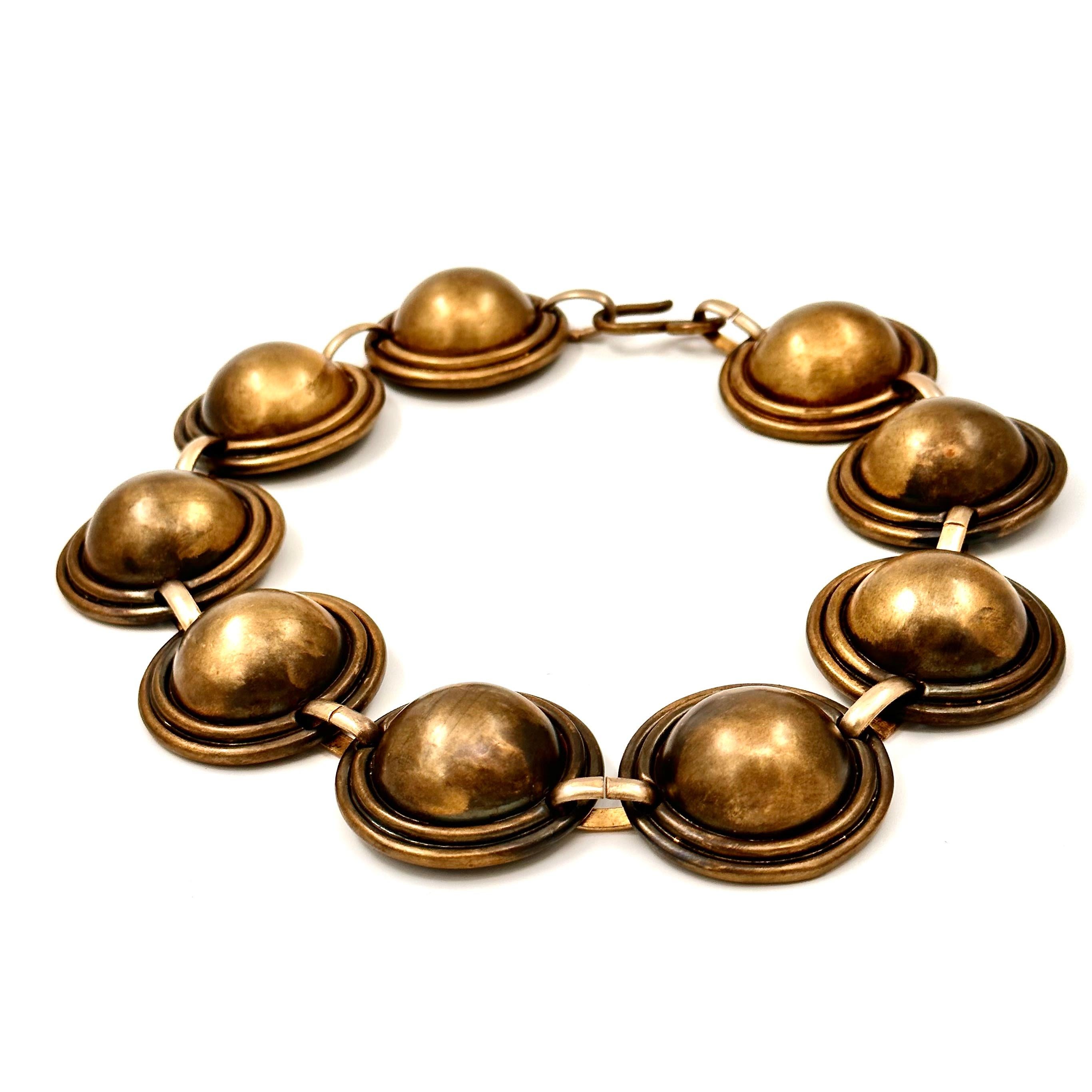 This bold strong and emphatic design is constructed of large oxidized brass domes, linked into a high fitting collar. Looking medieval and luscious, like out of a a movie, this beautiful and very simple necklace commands attention even in its more