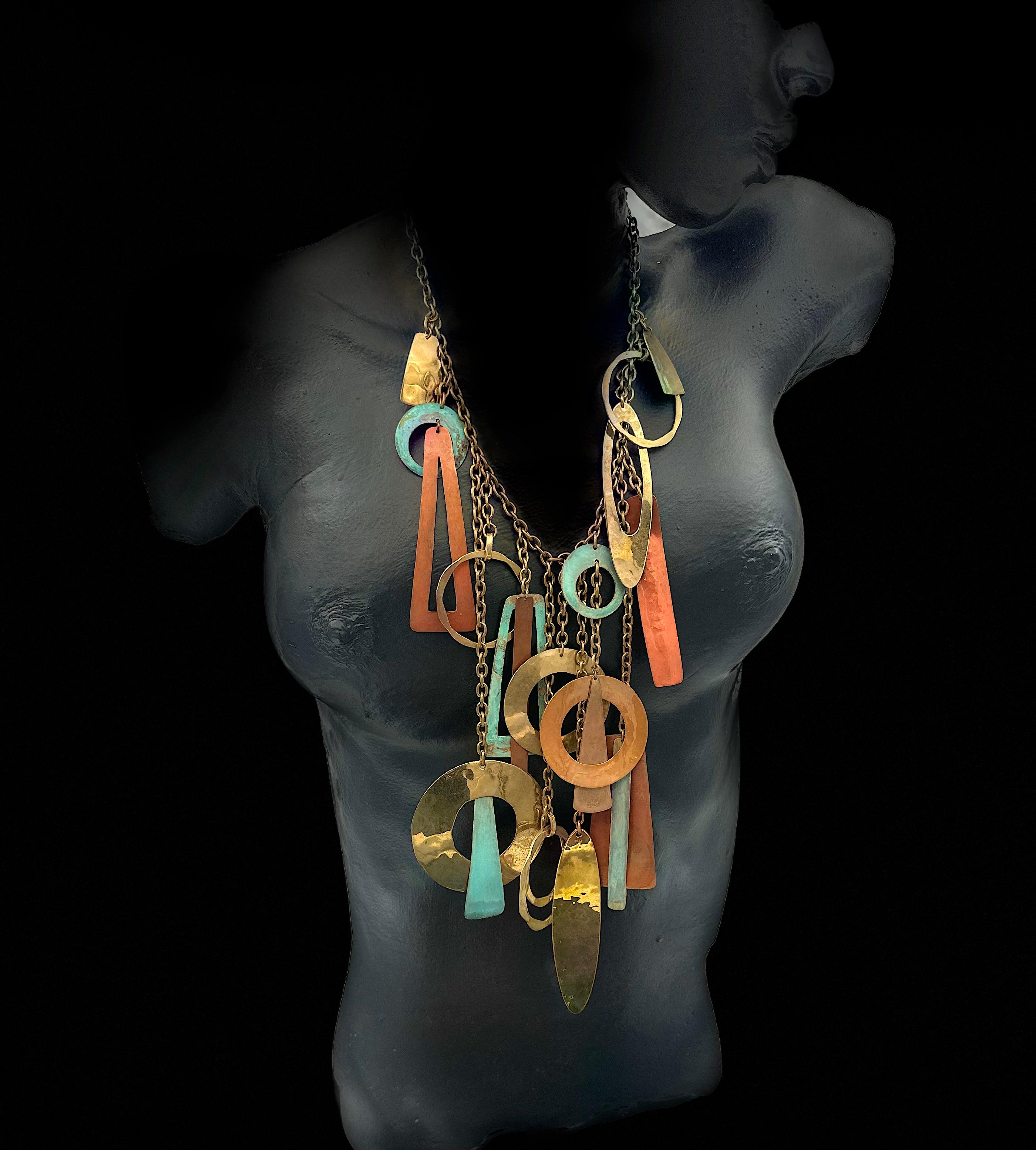 Robert Lee Morris is the designer who brought the rustic look of Wabi Sabi into his fashion jewelry and has helped to make it more mainstream. This one of a kind spectacular necklace is a symphony of colors and shapes hanging in a web of brass