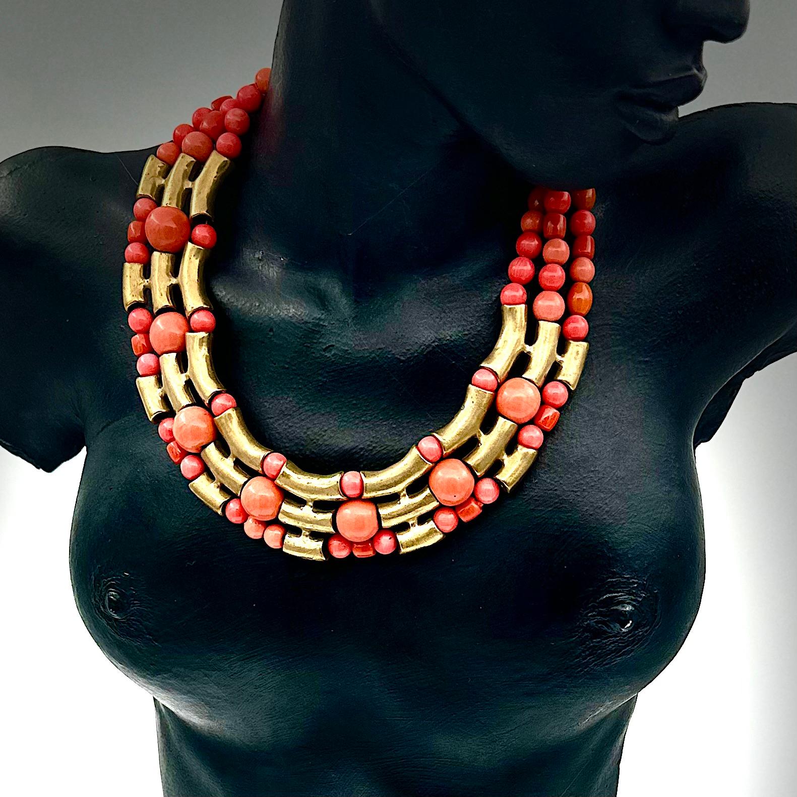 Robert Lee Morris Wabi Sabi Three Row Coral Necklace With Brass Bridges was created in 2011. The new system Morris designed utilized these sculpted and graduated tubular sections that acted as stations that defined and shaped the beads. These are