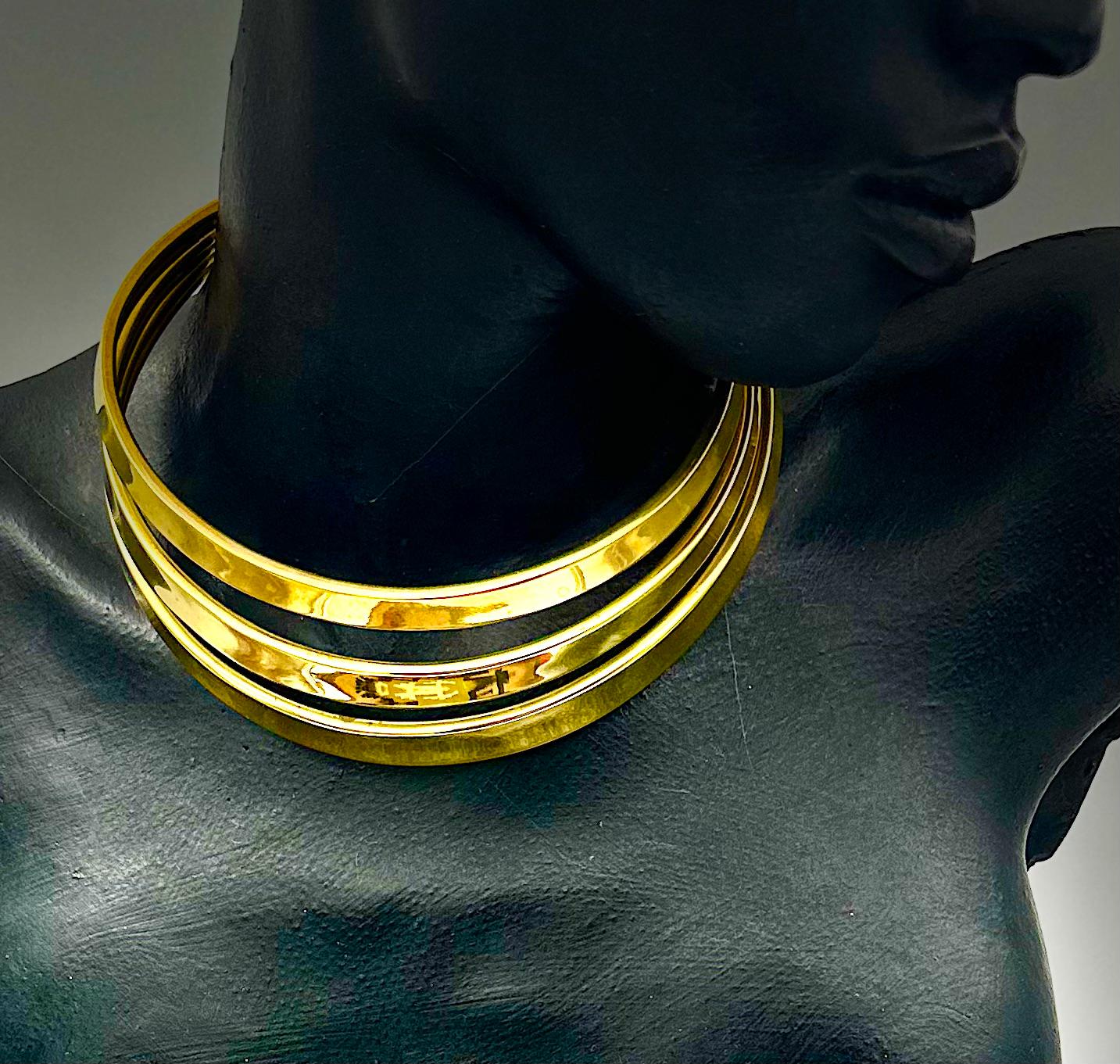 This spectacular brass collar is very dramatic and strong. It is easy to get on and off as the fit is perfect for an average female neck, and the positive negative effect is stunning. Three separately made concave collars with prominent edging, are