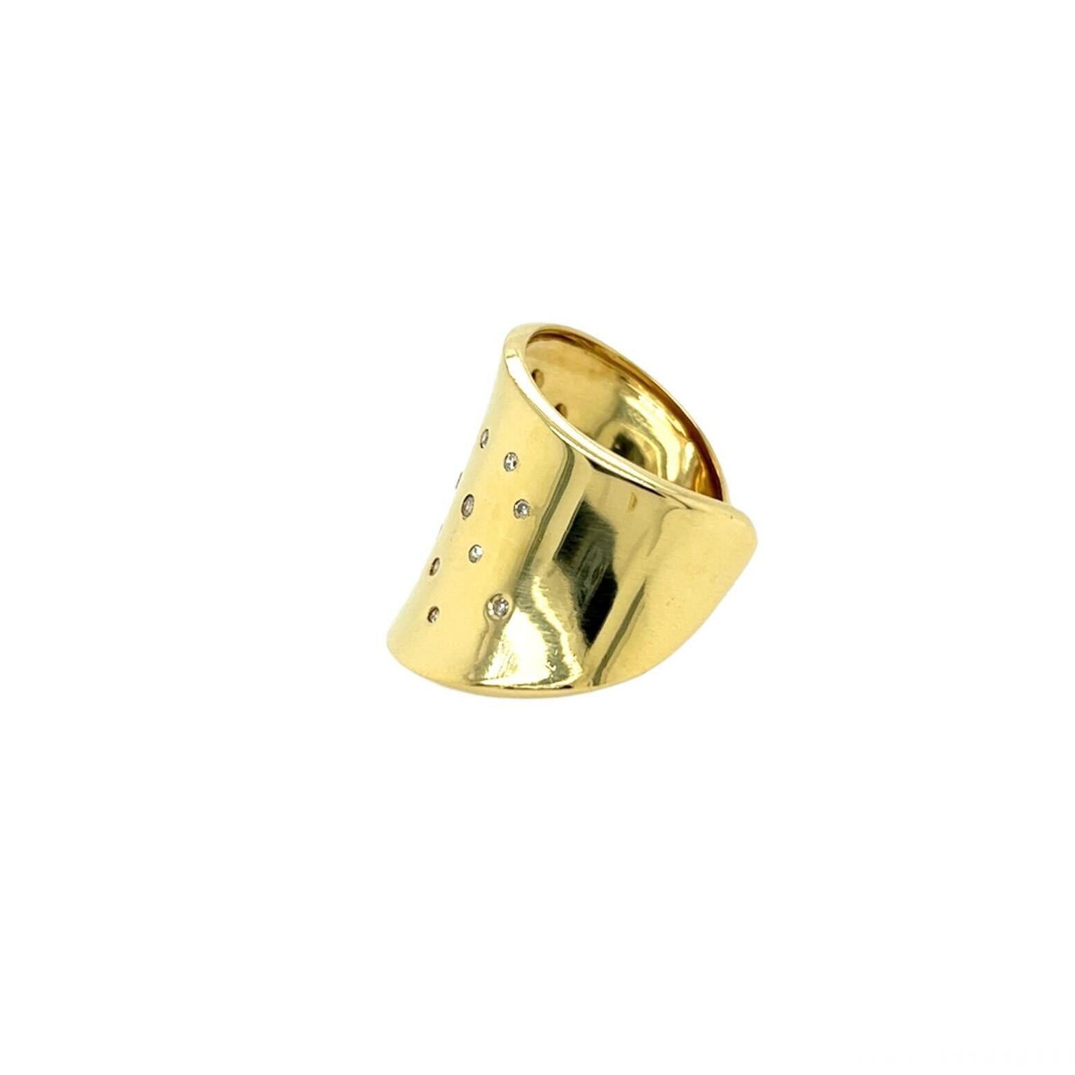 An 18 karat yellow gold and diamond ring, Robert Lee Morris.  Designed as a long sculptural form flaring at each end and open at the back scattered with twenty one brilliant cut diamonds.  Total diamond weight approximately 0.47 carat.  Size