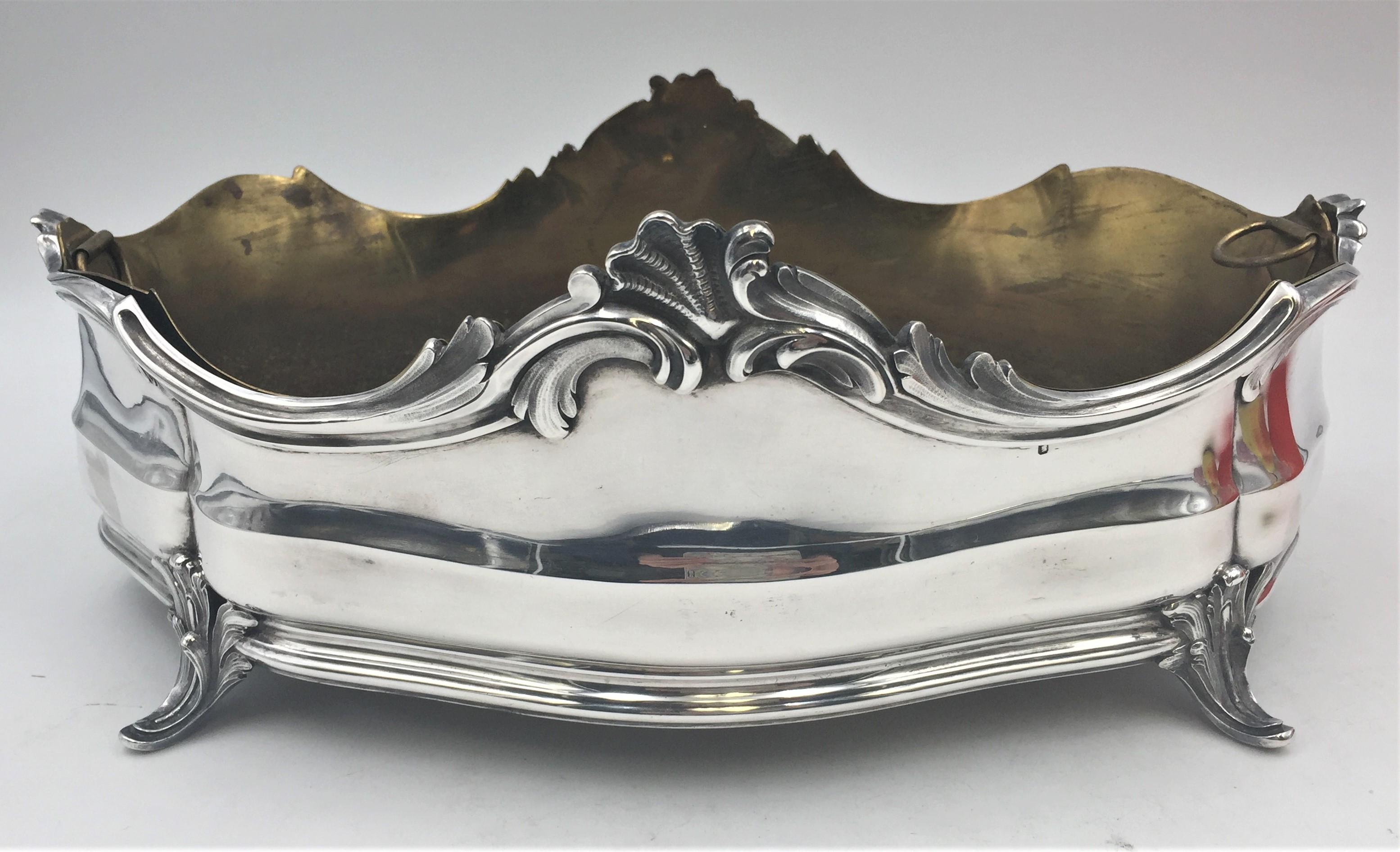 Robert Linzeler, French 0.950 silver centerpiece in ornate Rococo style with stylized motifs on the 4 feet and around the rim as well as an original, brass insert. It measures 13'' in length by 9'' in width by 5'' in height, weighs 40.7 ozt without