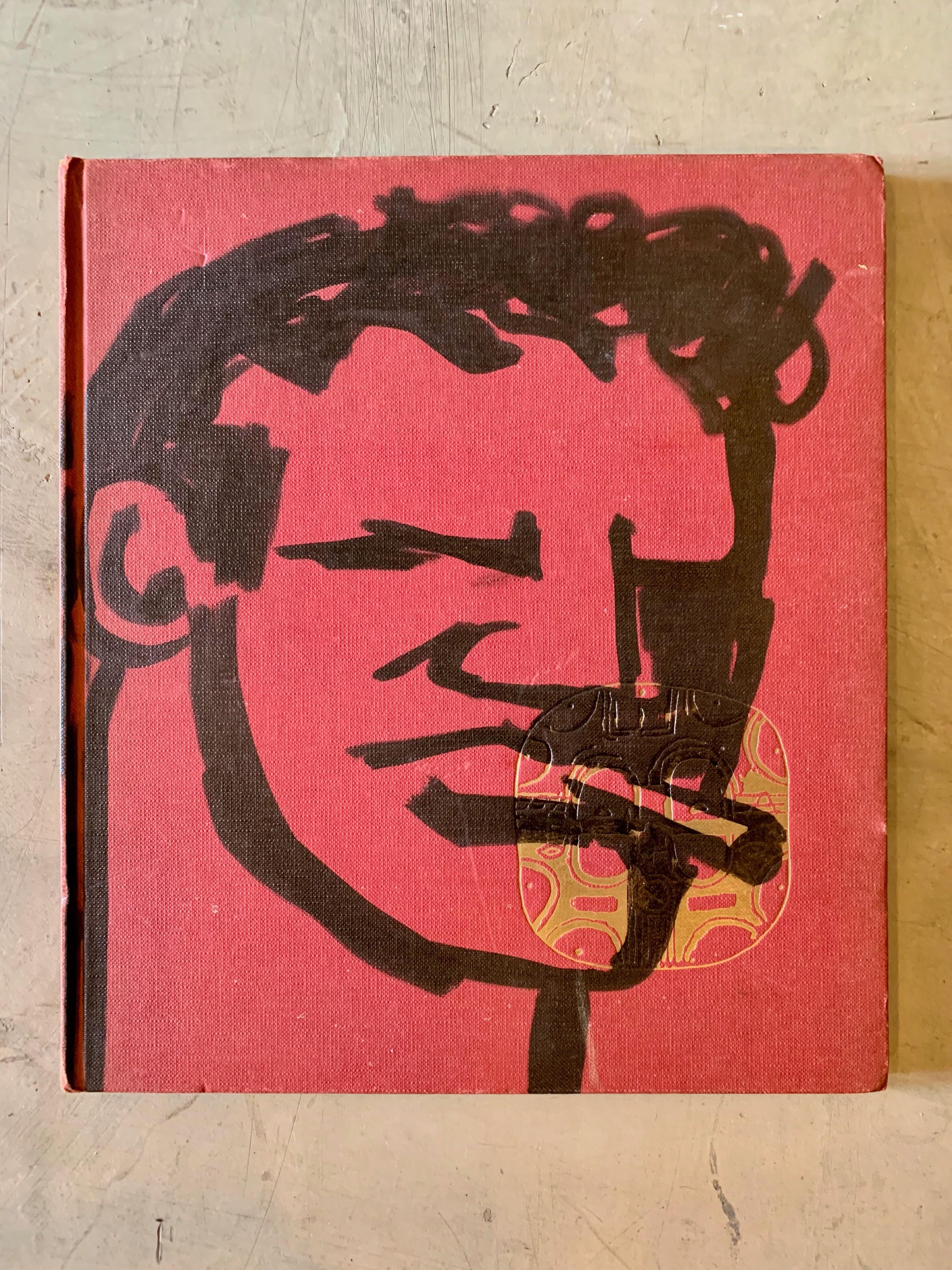 Fantastic original drawing by Robert Loughlin on an old book. Vintage African Art book. Red book with black drawing of 'the Brute' on the cover. Signed RL and dated 2003 on the inside. 

   